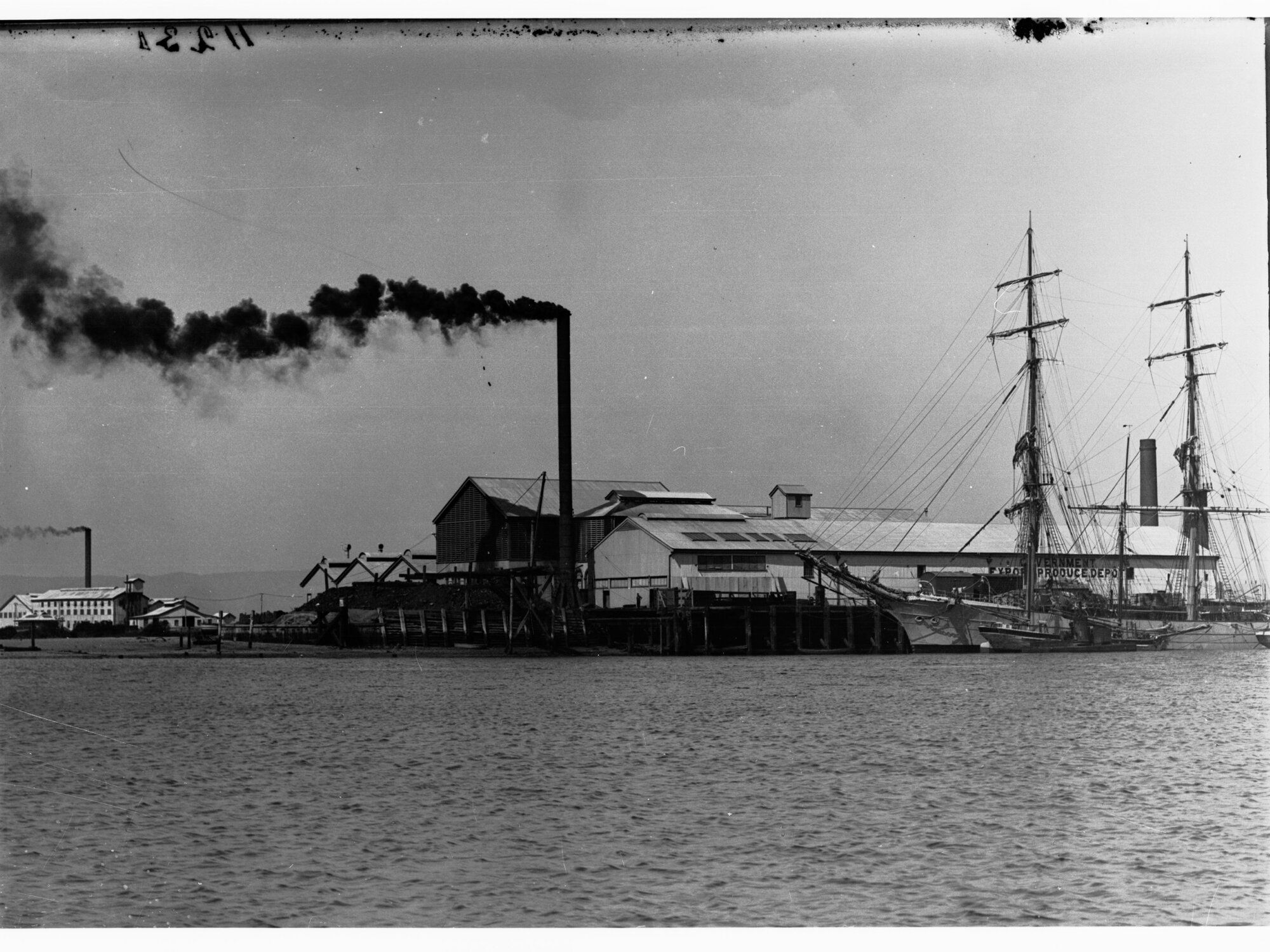 Exterior of Government Produce Department showing sailing ship berthed