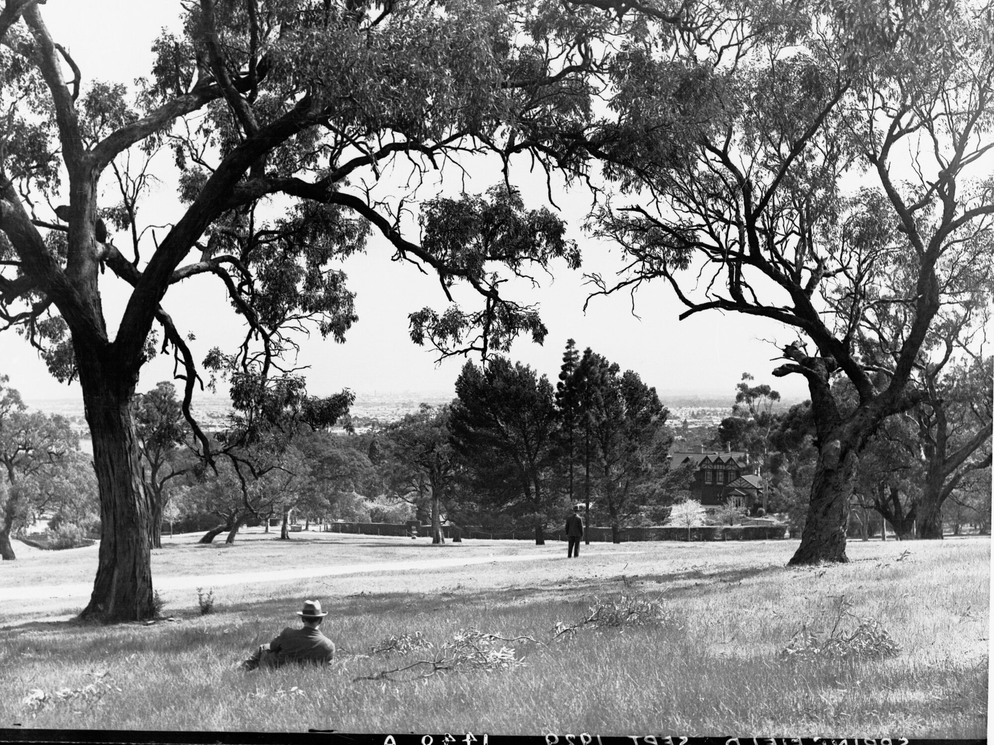 Men Lying on Grass at Springfield House in Distance