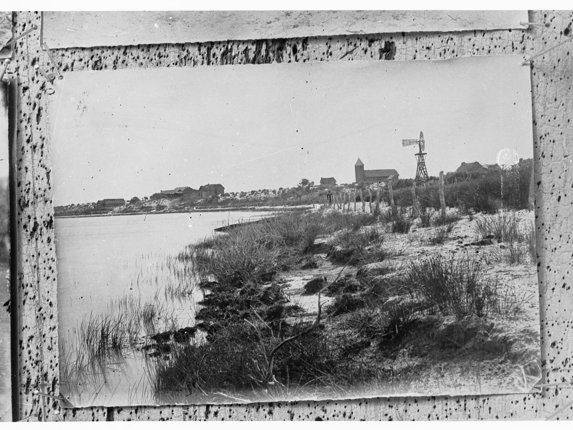 Killalpannina Mission,  view of lake showing windmill and buildings, far north-east South Australia.