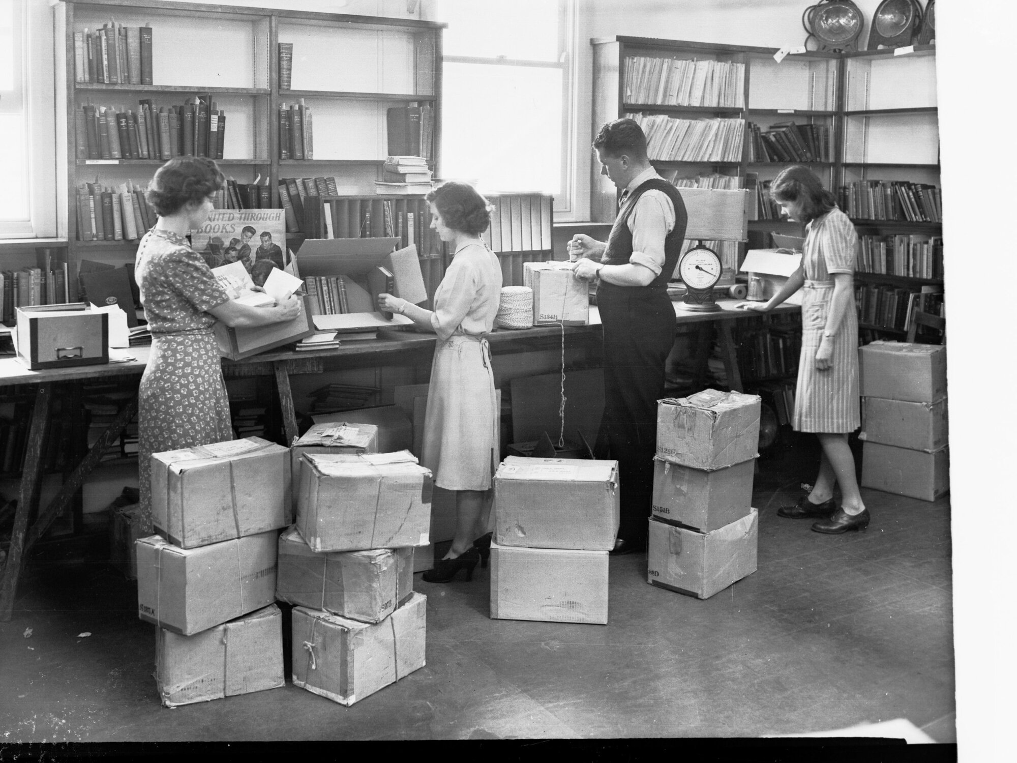 Students and Teachers Packing Books in Boxes for Schools Public Library