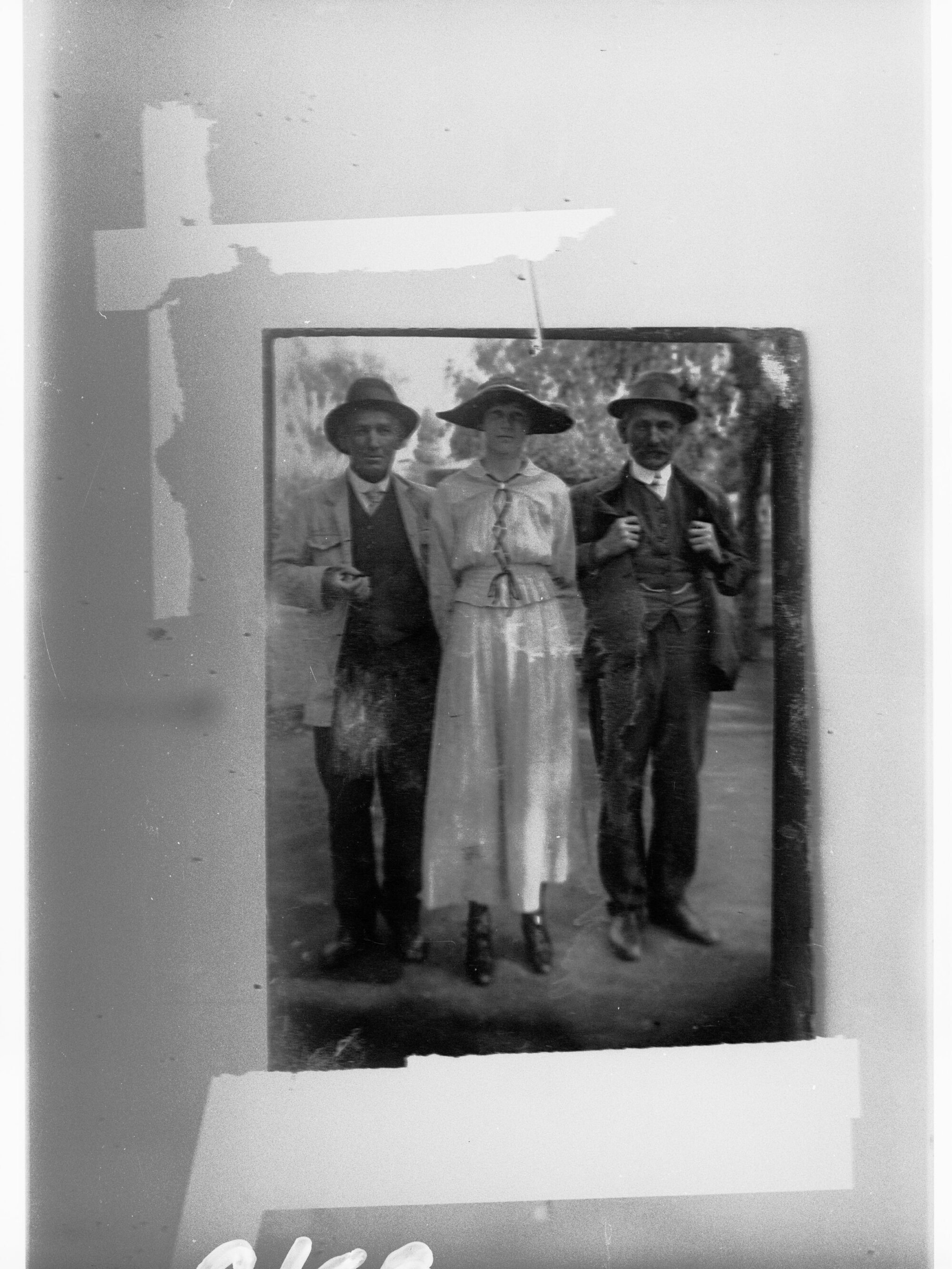 Two men with a woman standing between them