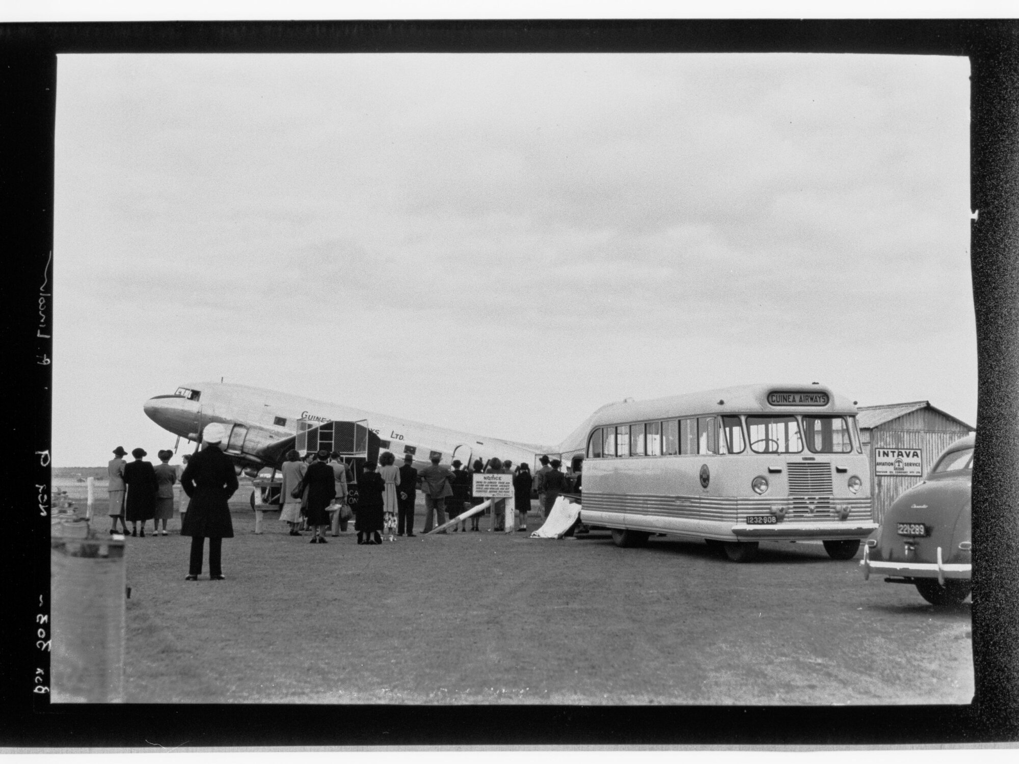 People standing around Guinea Airways Ltd plane