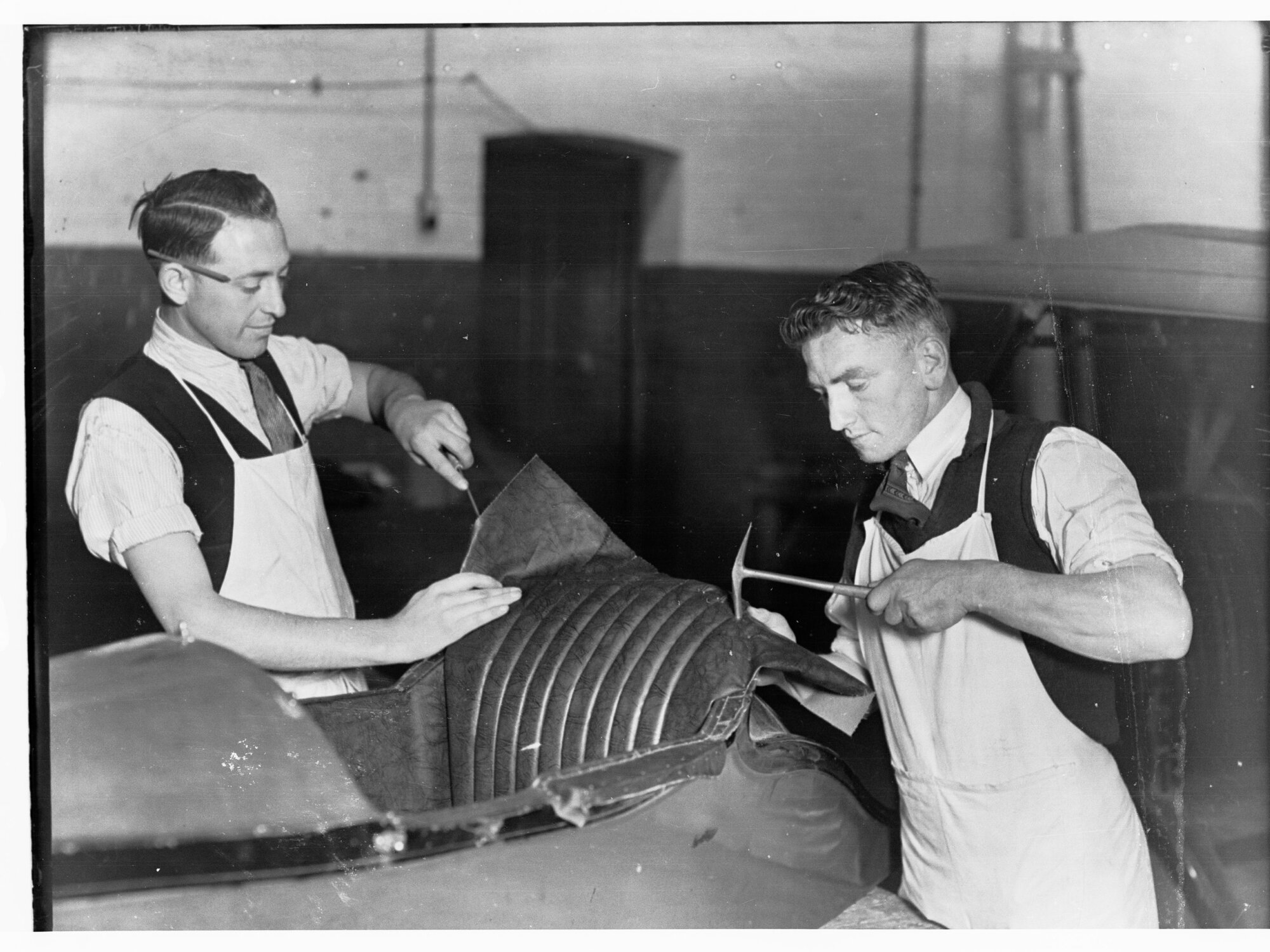 Students re-upholstering side-car for motorcycle at trade school