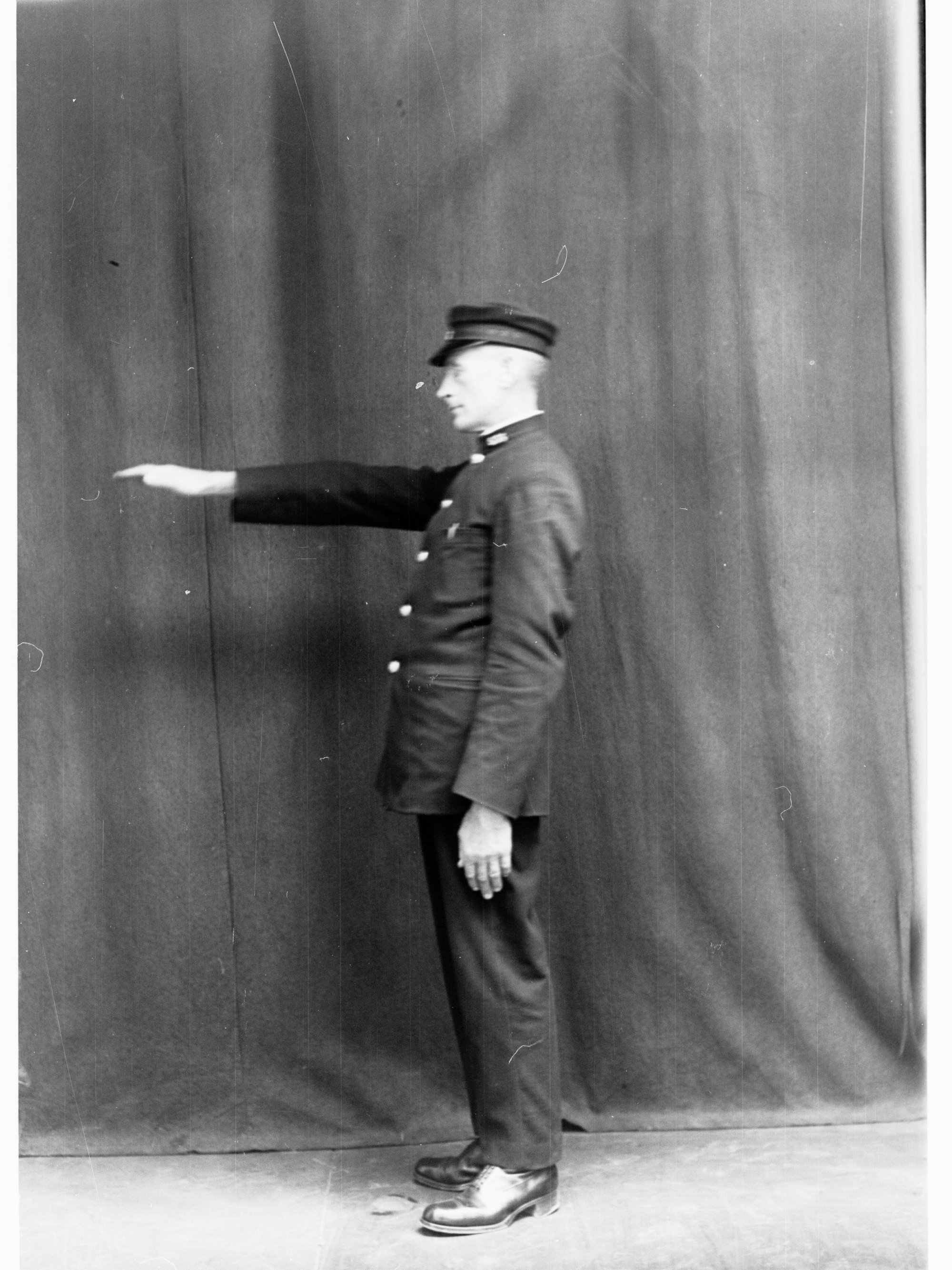 Porter demonstrating railway hand signals