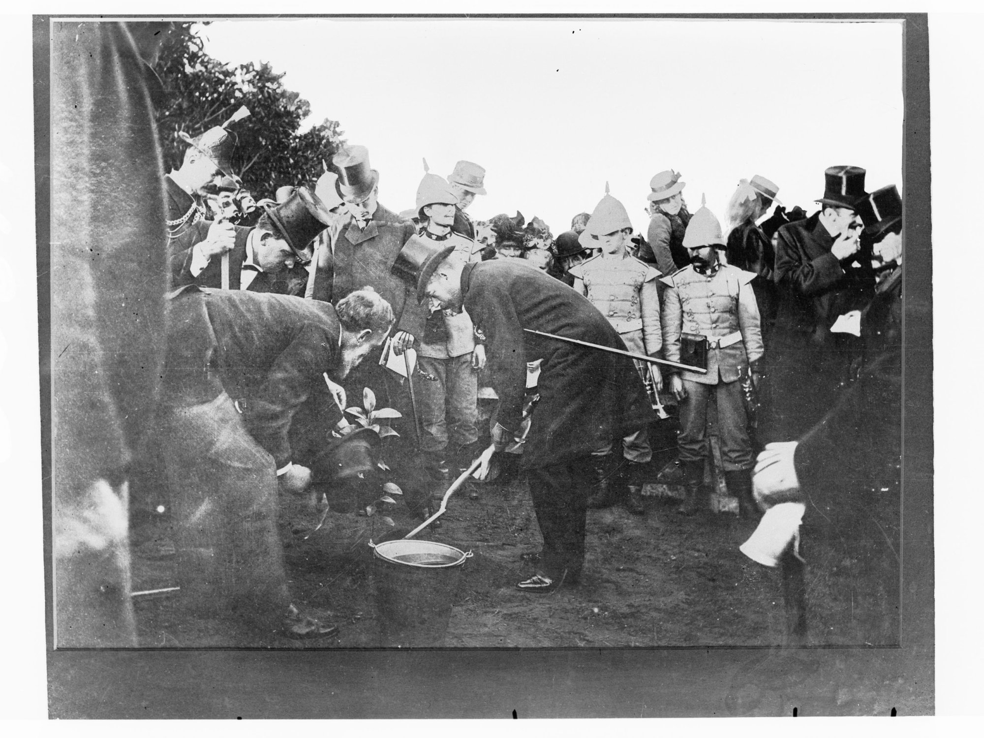 Group of officials and Governor Tennyson at tree planting ceremony, South Australian Volunteer Forces in attendance.  Duke of York also in the photograph.