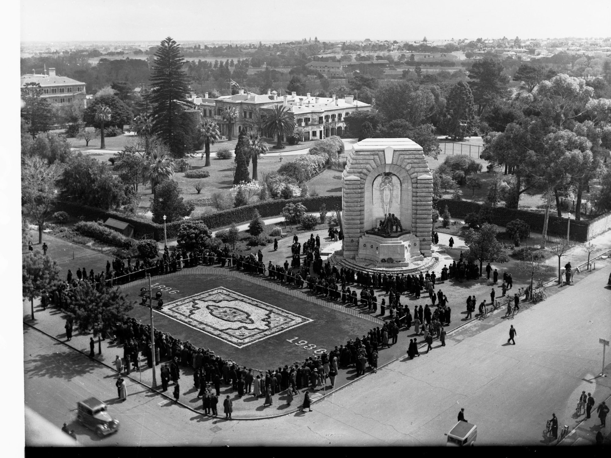 Floral carpet on North Terrace showing Government House and National War Memorial for Adelaide Centenary,