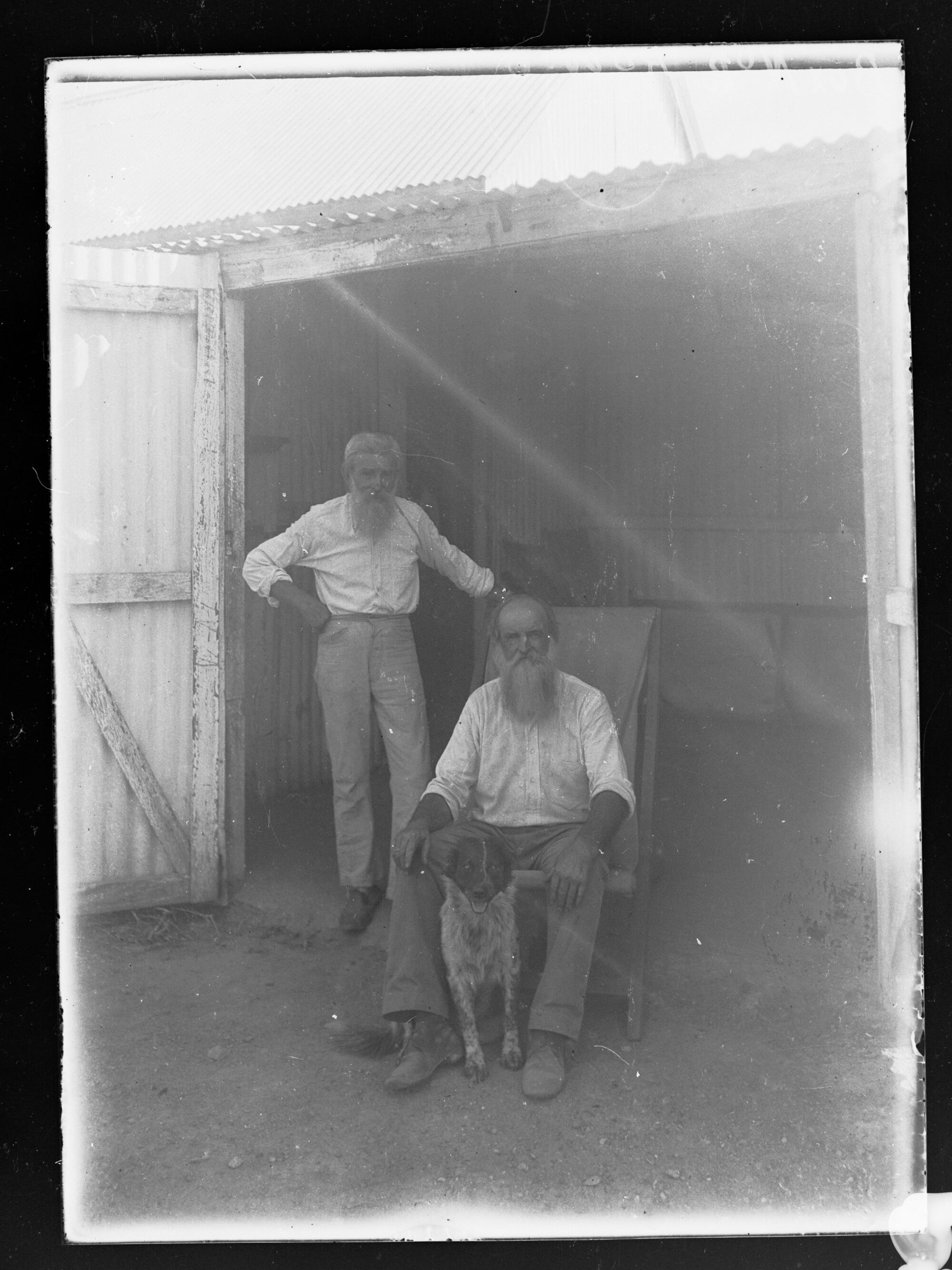 Two men outside shed, c.1905