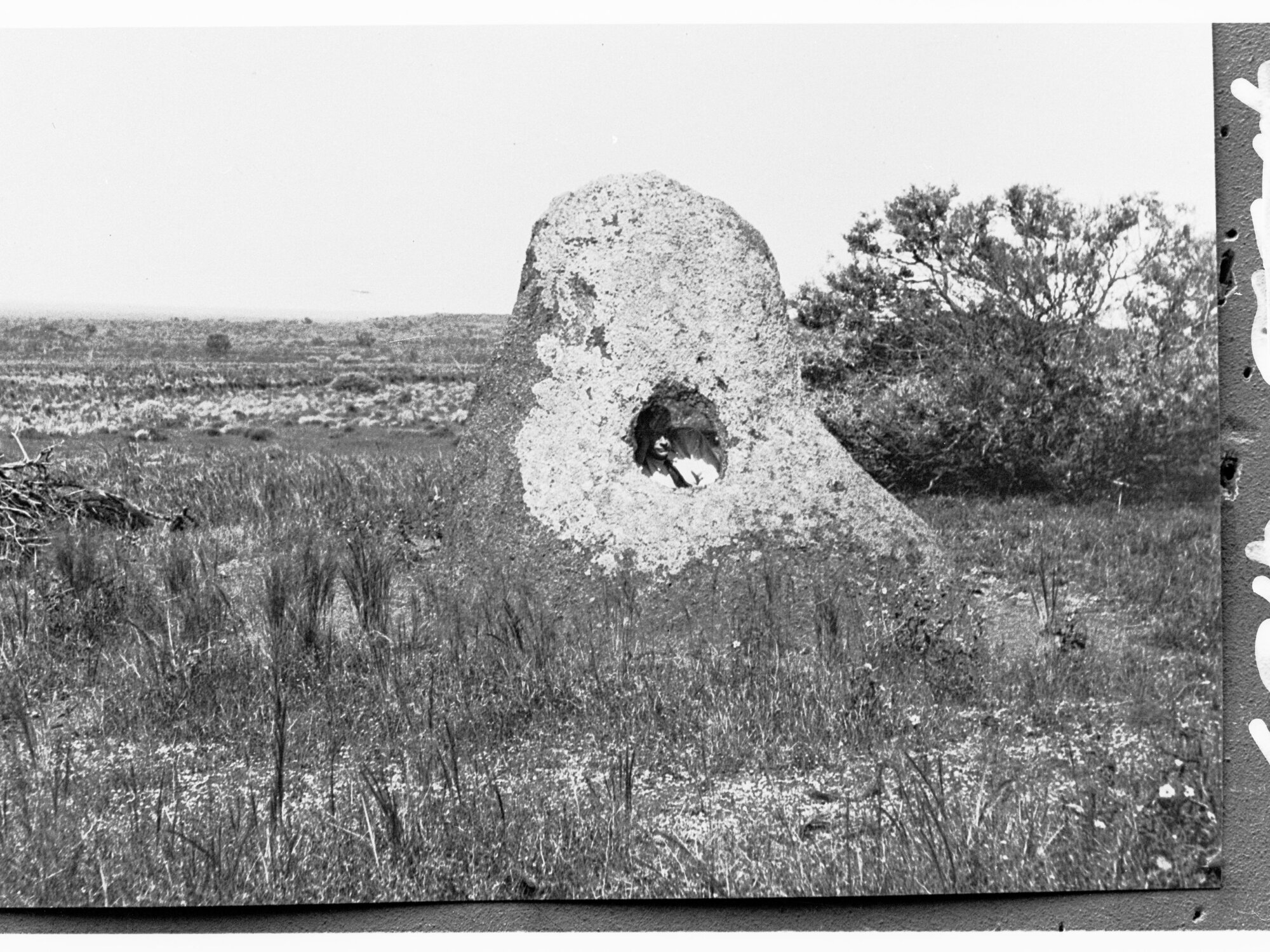 Rock formation in central Australia (man inside looking out) - location unknown