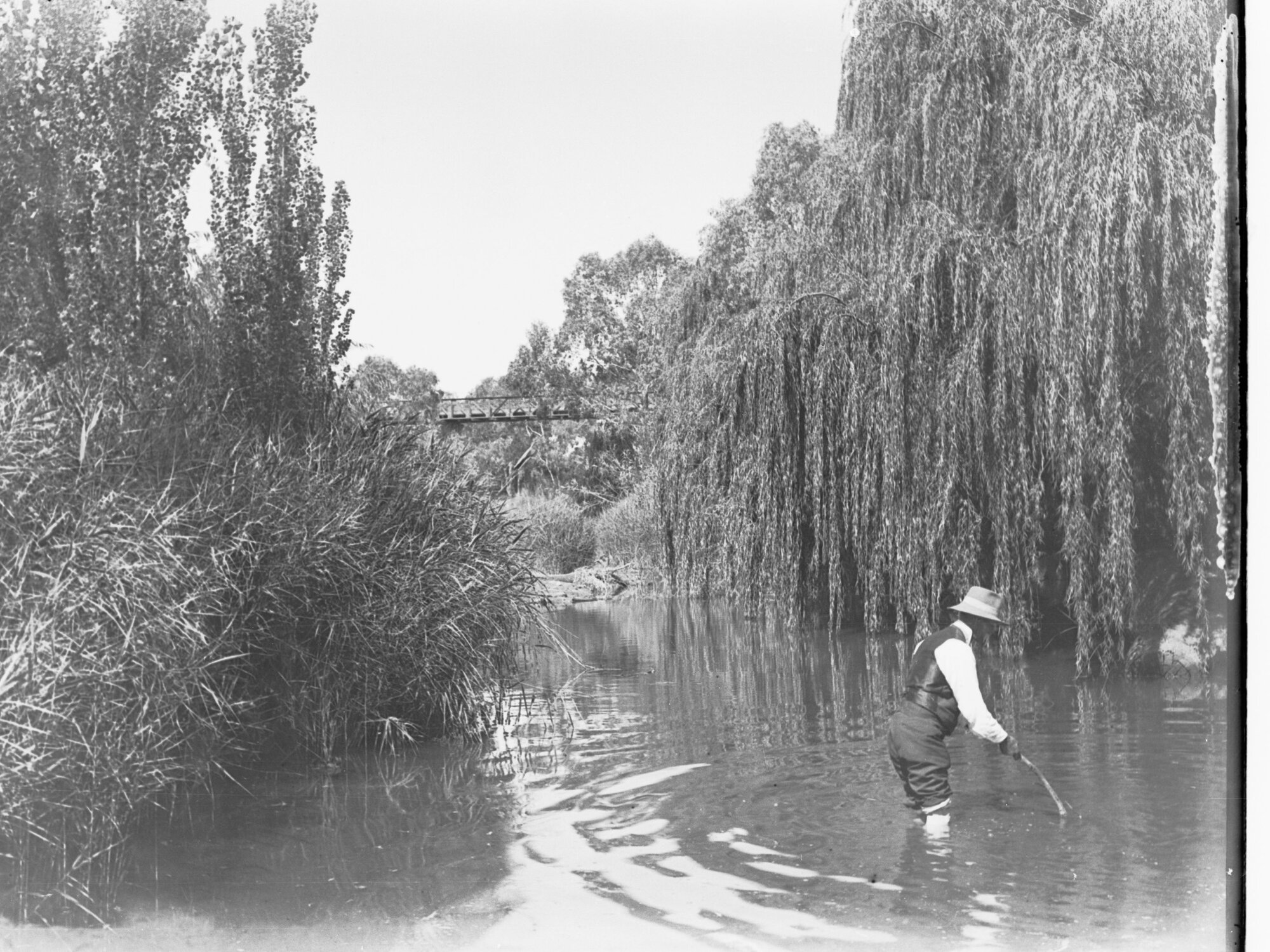 Man standing knee-deep in water