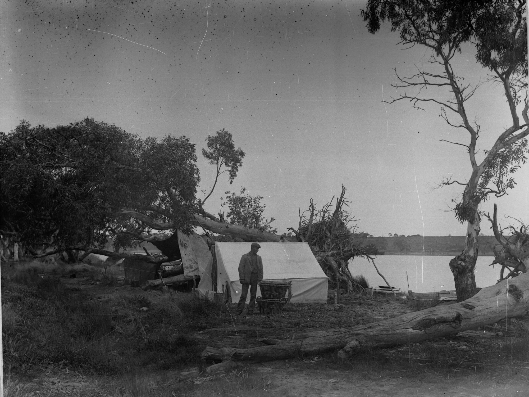 Campsite by river showing man