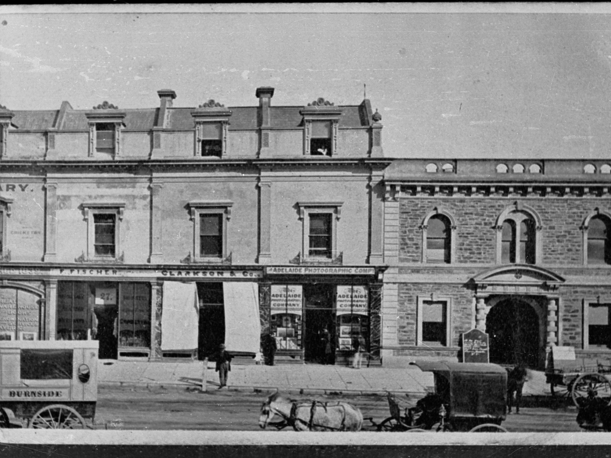 Street scene with carriages in foreground, also showing Adelaide Photographic Company.  Clarkson and Co.