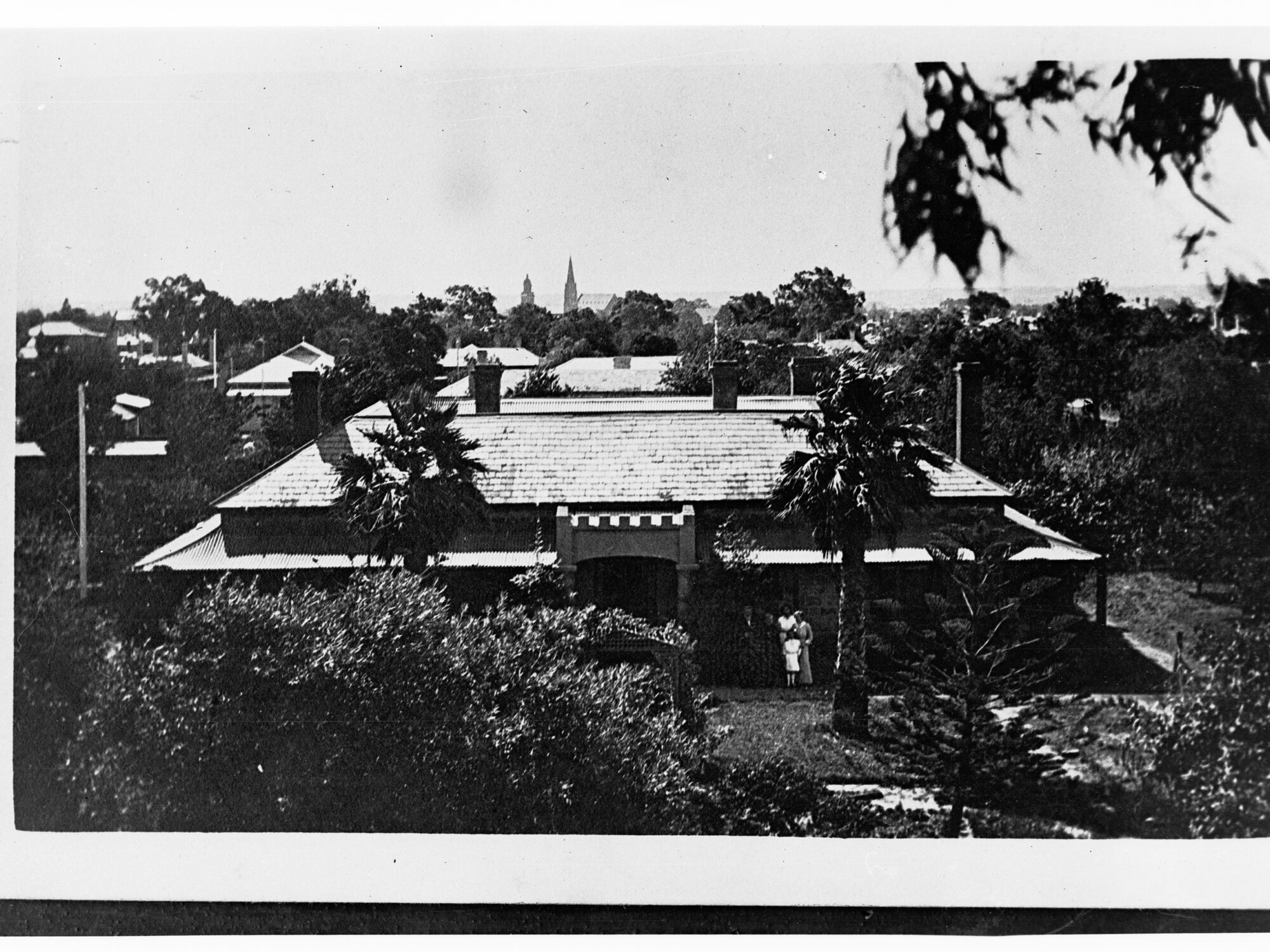 House Showing Family on Front Verandah