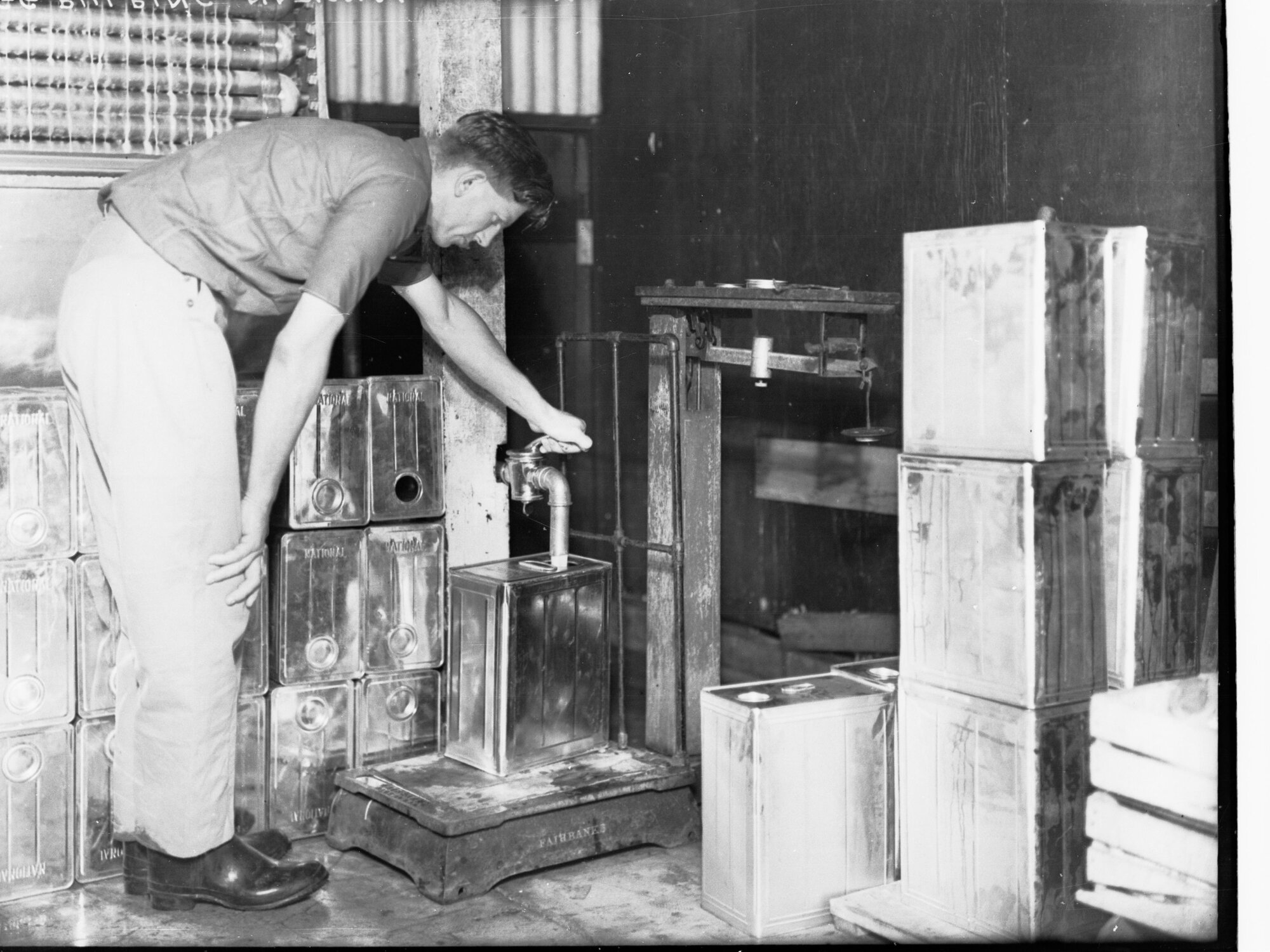 Egg pulping at Farmer's Union, man filling cans