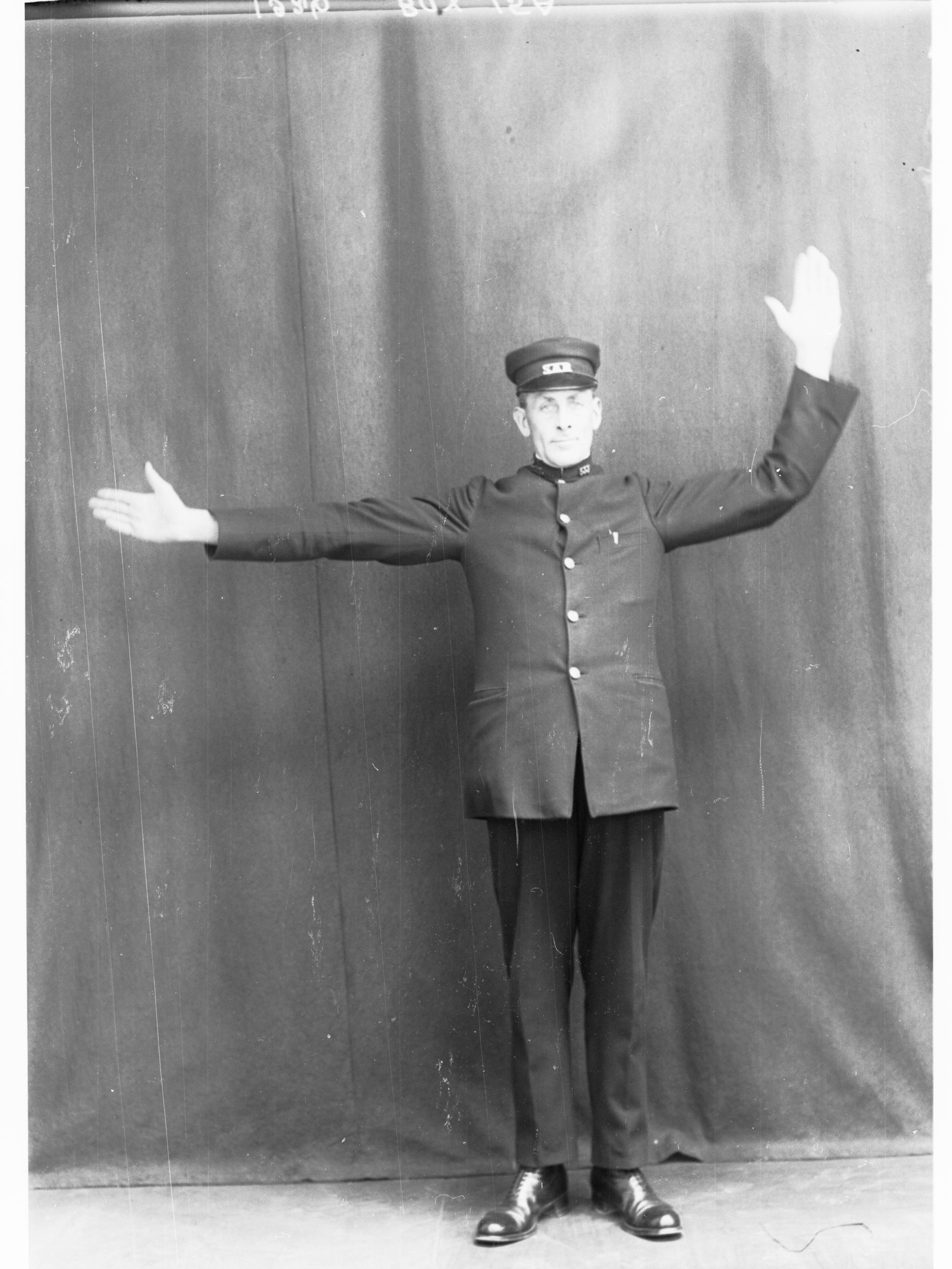 Railway Porter demonstrating railway hand signals