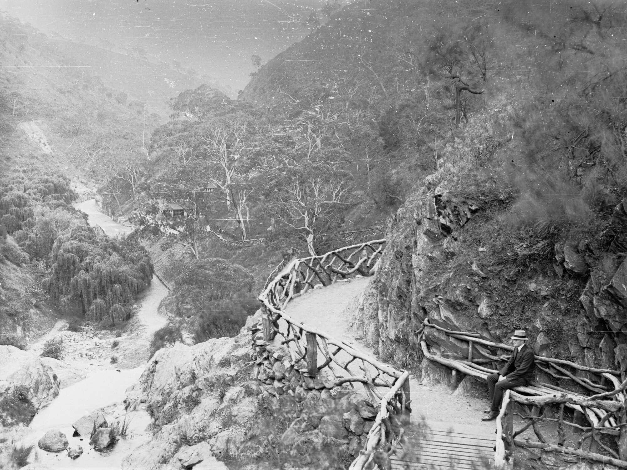 Man sitting on a bench at Waterfall Gully