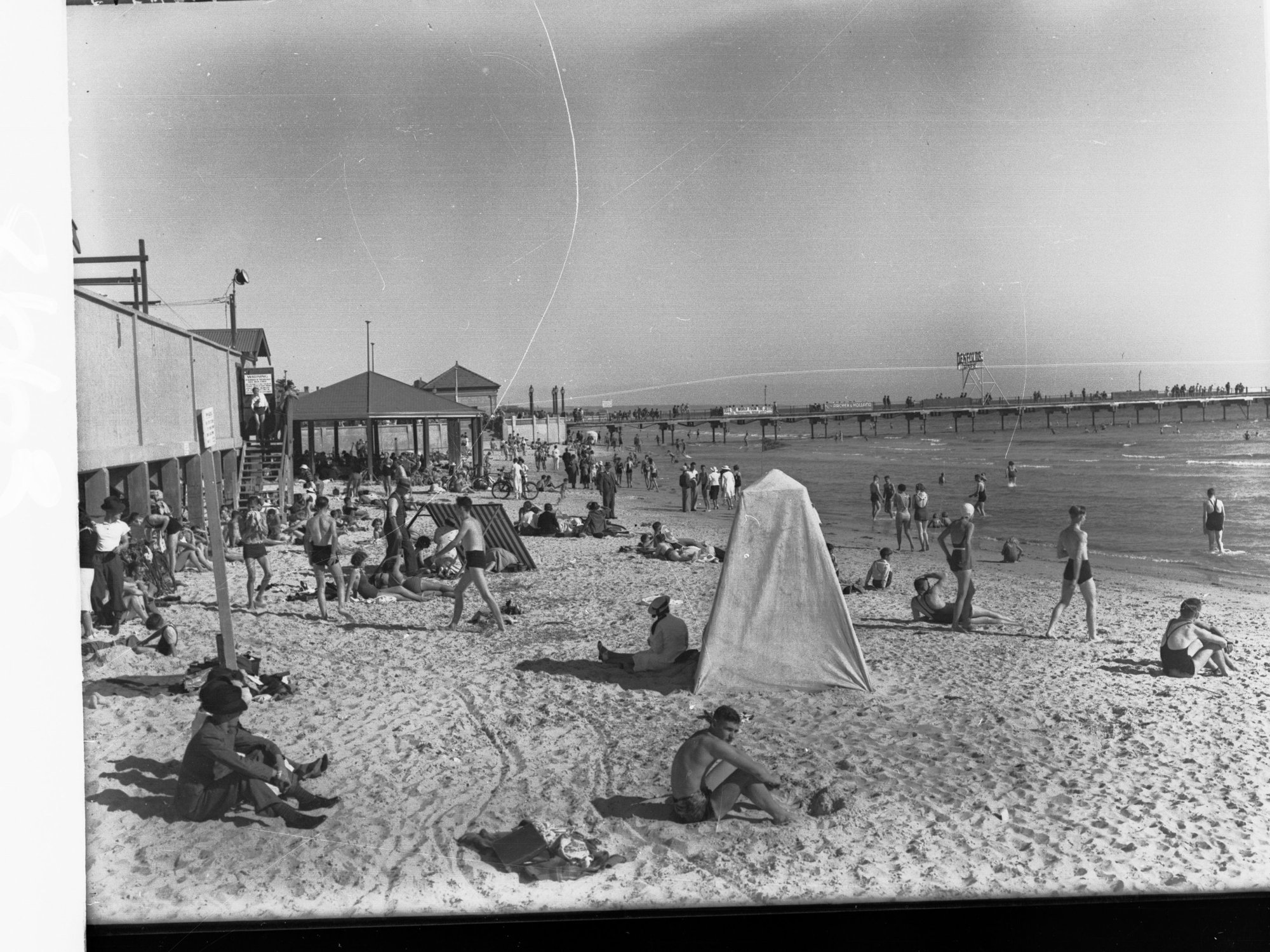 Glenelg Beach Showing People Sunbathing Near Jetty