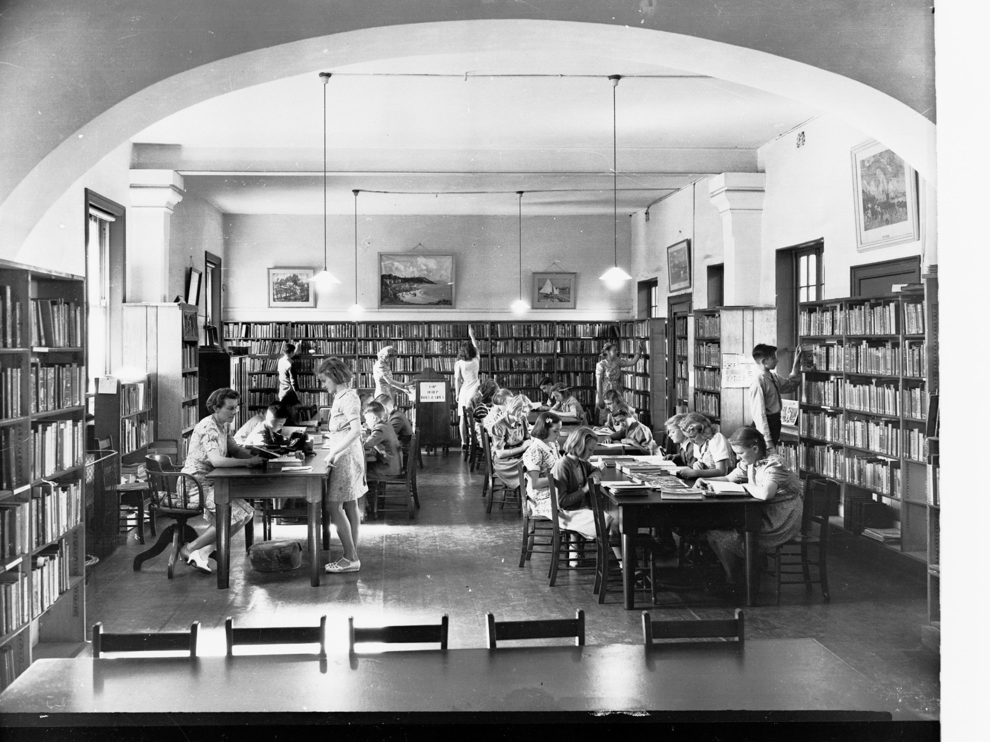 Students Reading at Tables in School Library