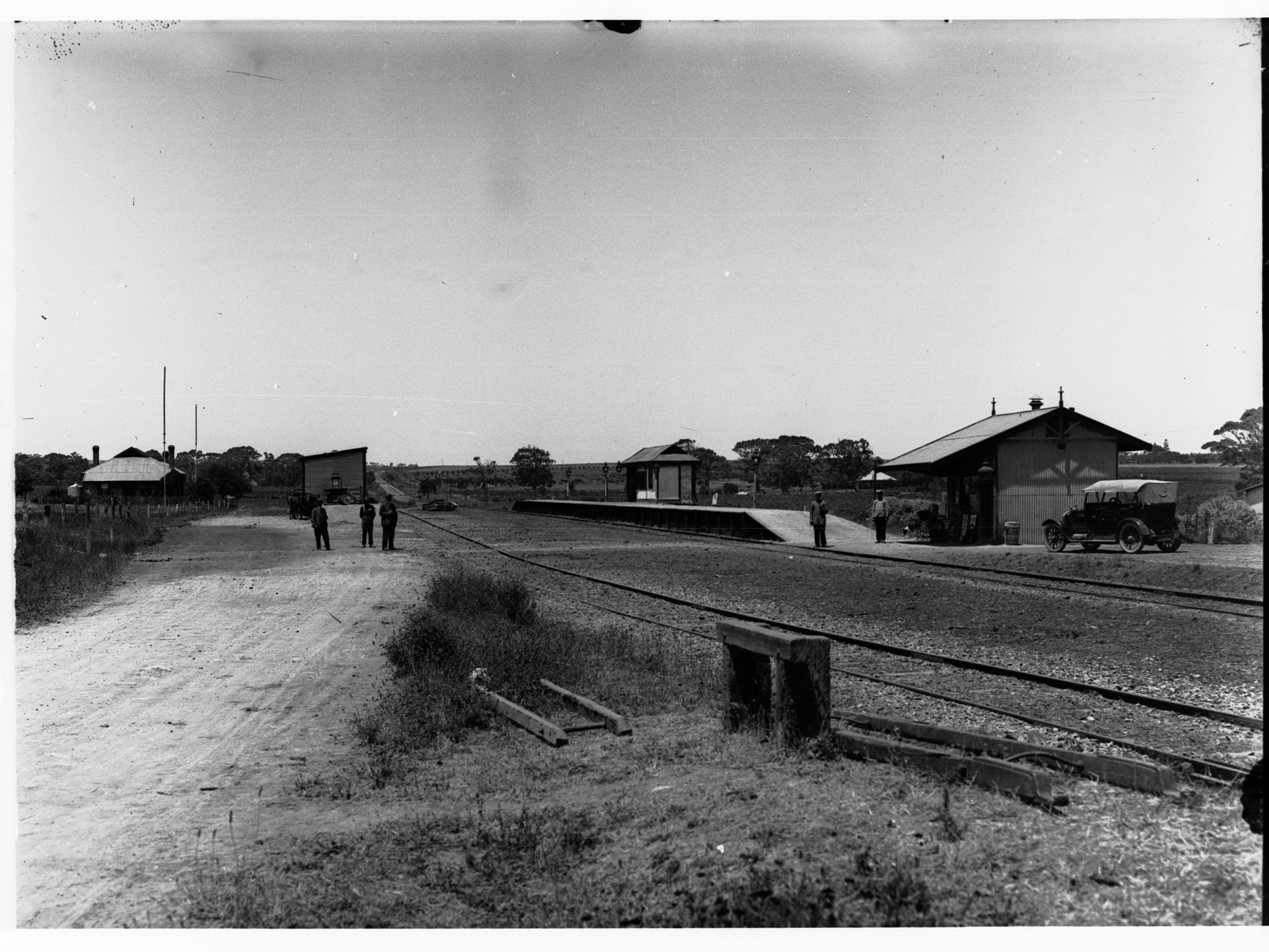 Morphett Vale Railway Station - automobile parked by station, house in background