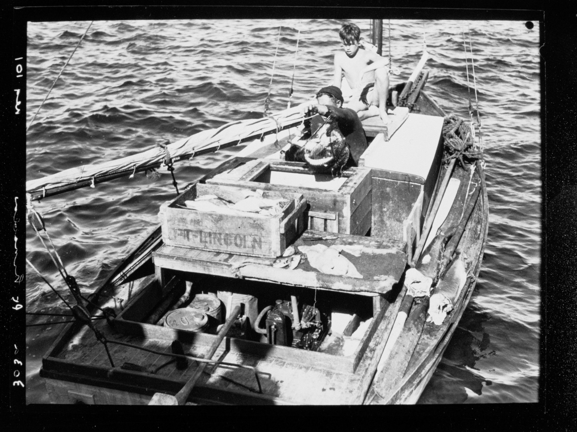 Man and boy in fishing boat, Port Lincoln