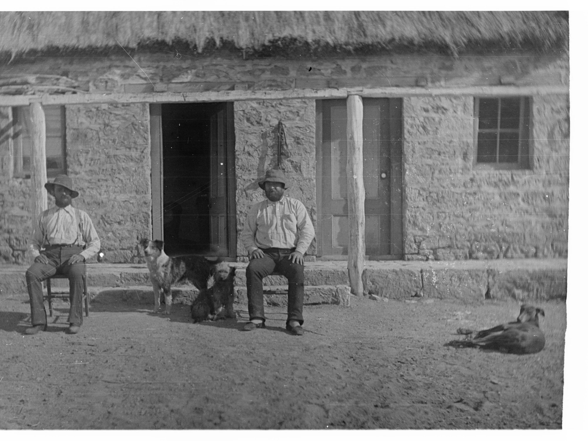 Two Macdonalds Sitting Outside Hut at Cootanoorina Elder Expedition