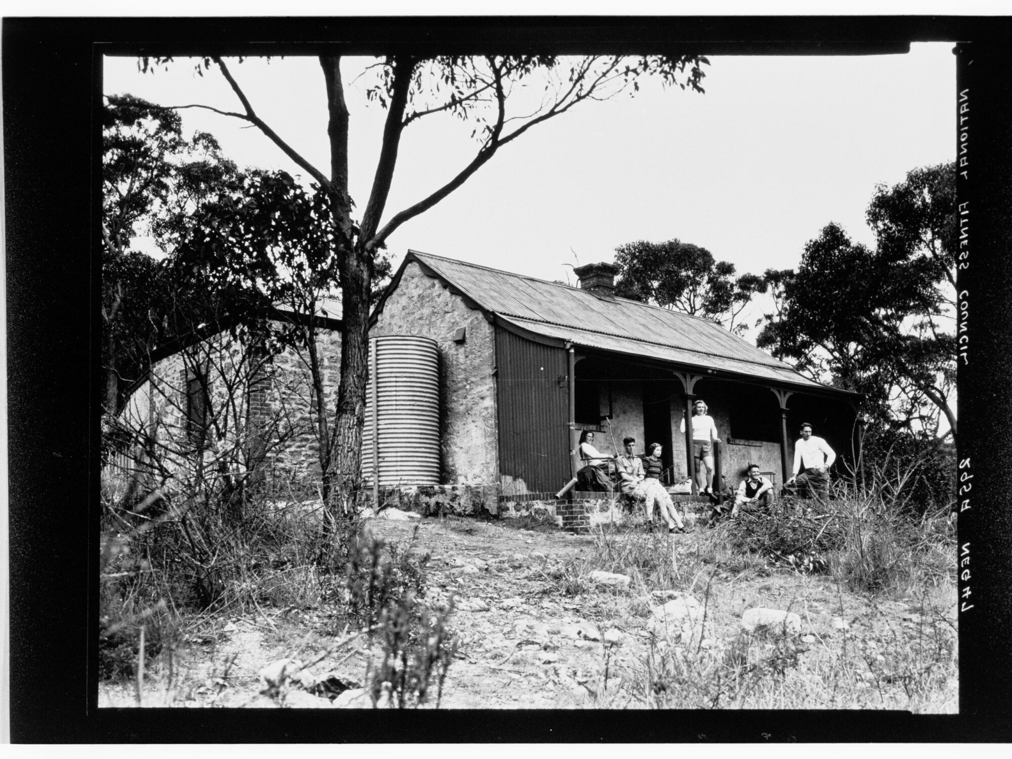National Fitness Council - people outside a stone cottage