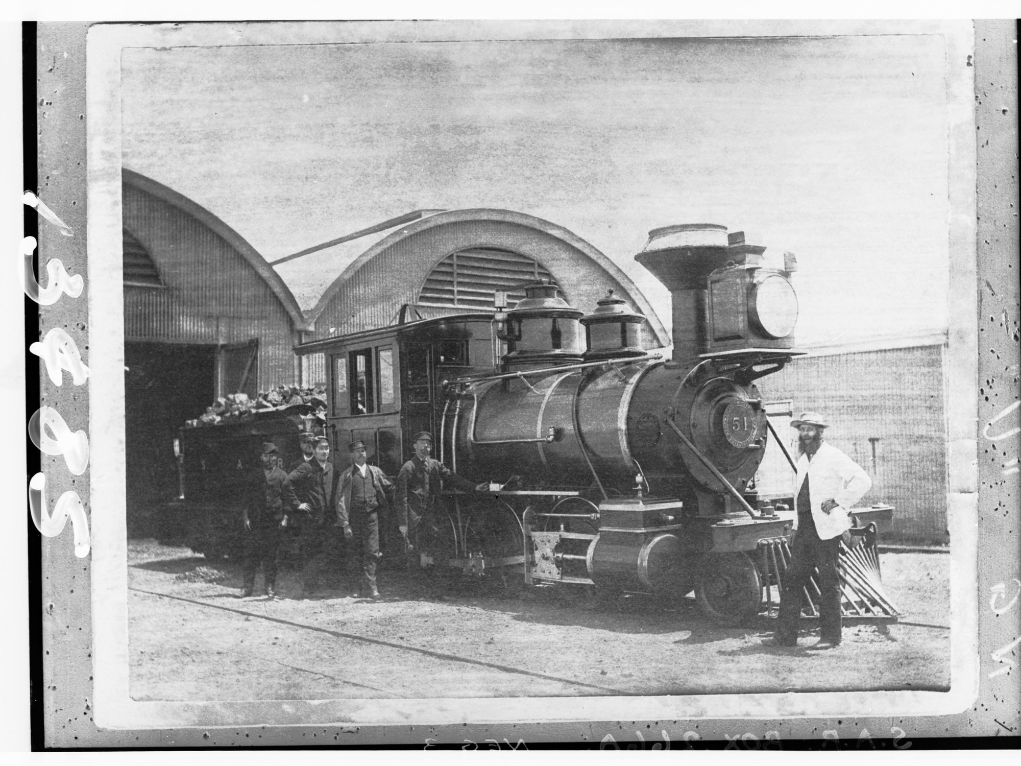 Steam locomotive showing railway employees