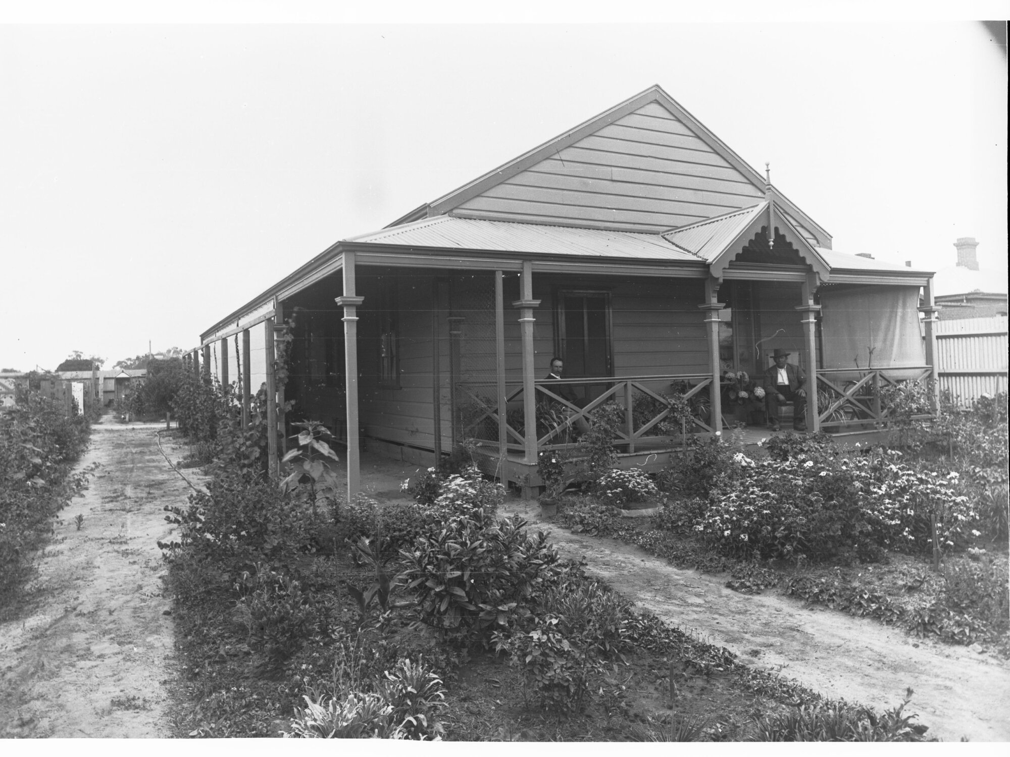 Men Sitting on the Verandah of a House