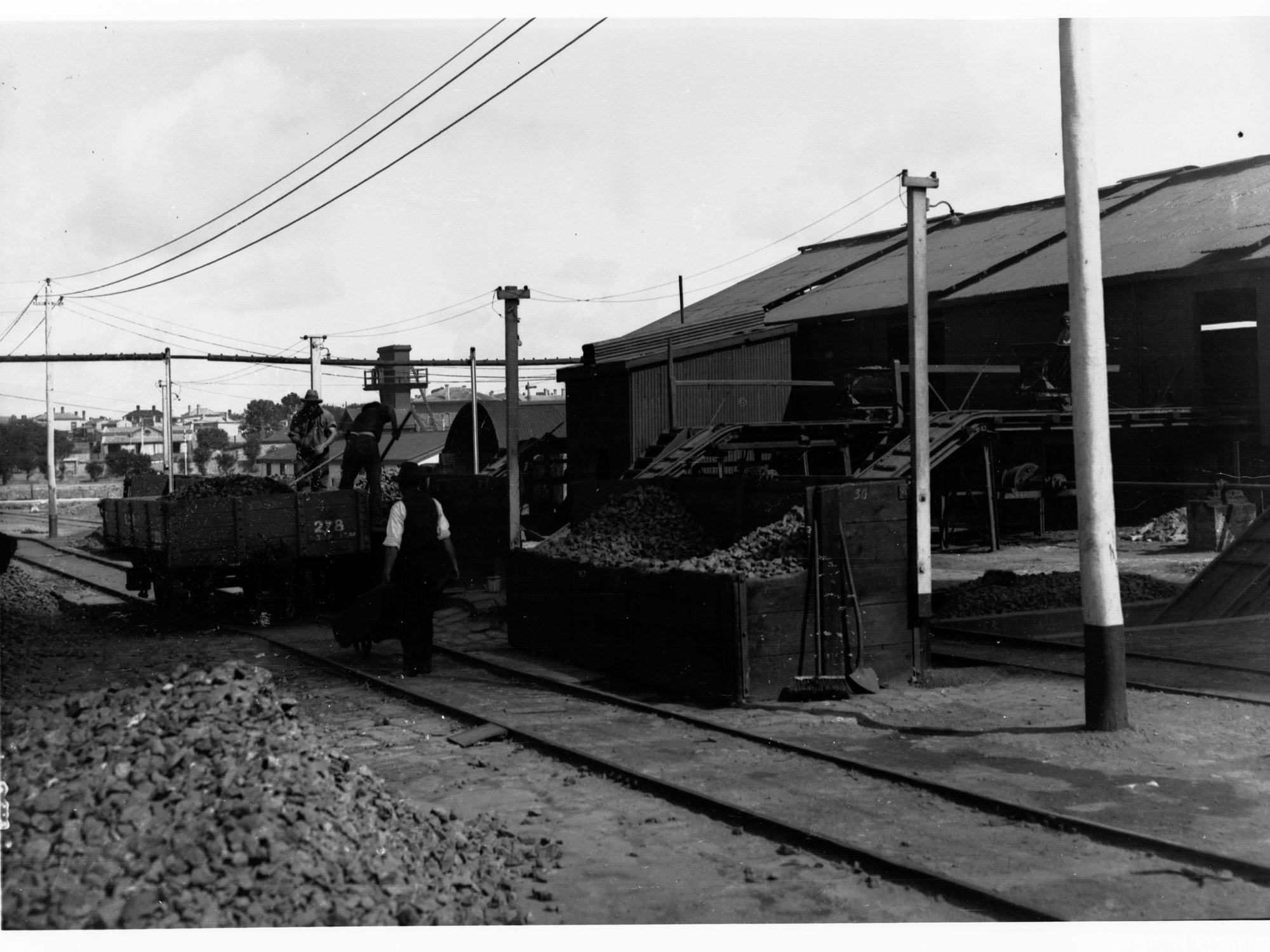 Wallaroo Mines, unloading rough ore into acid burners, showing men working