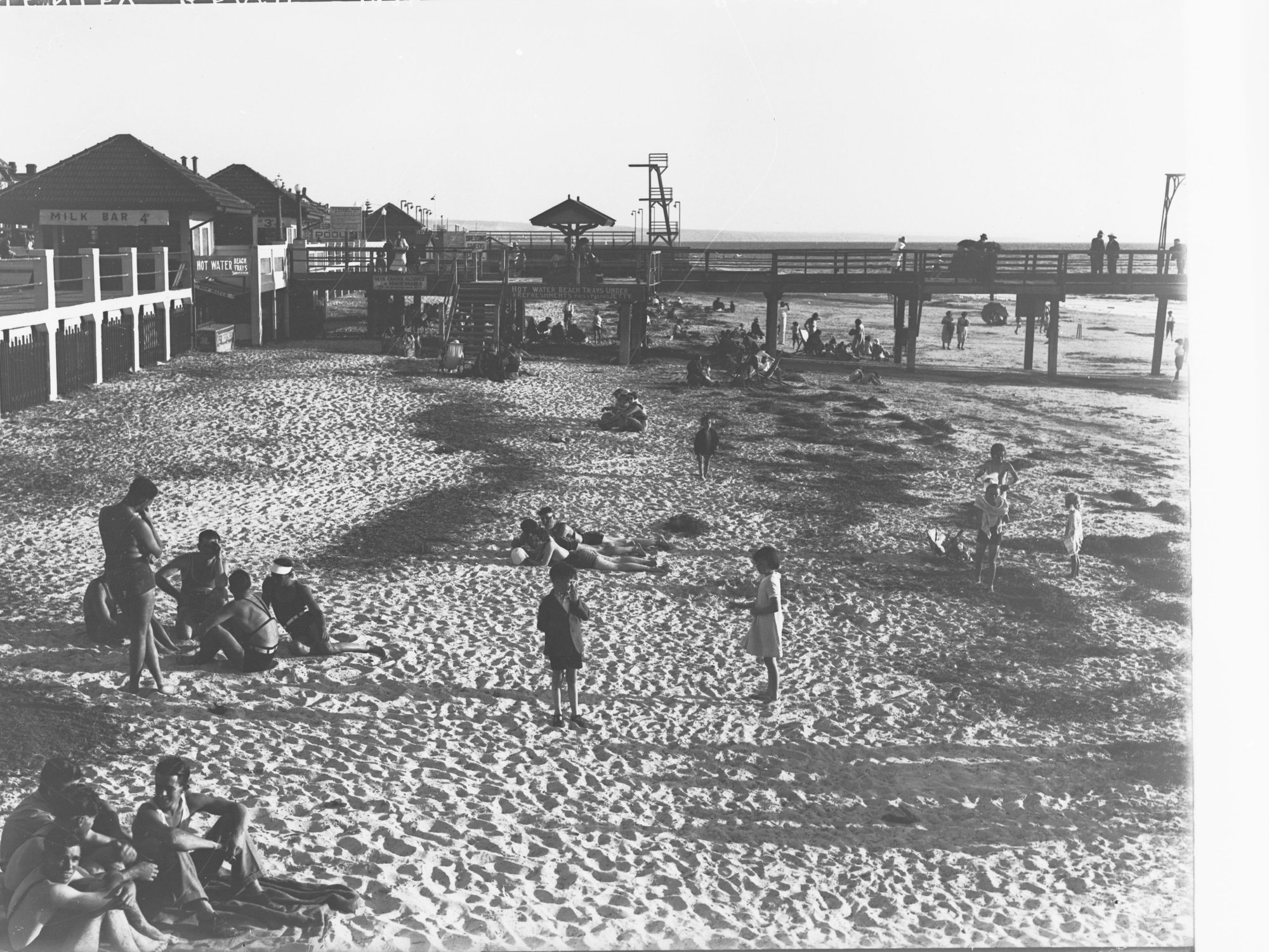 Henley Beach showing children and adults sunbathing on beach