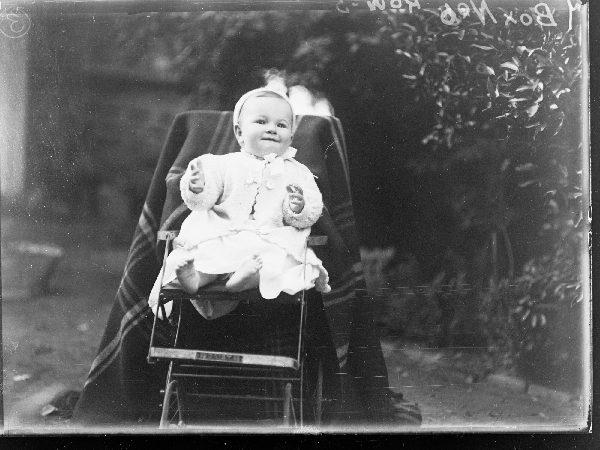 Baby sitting in garden