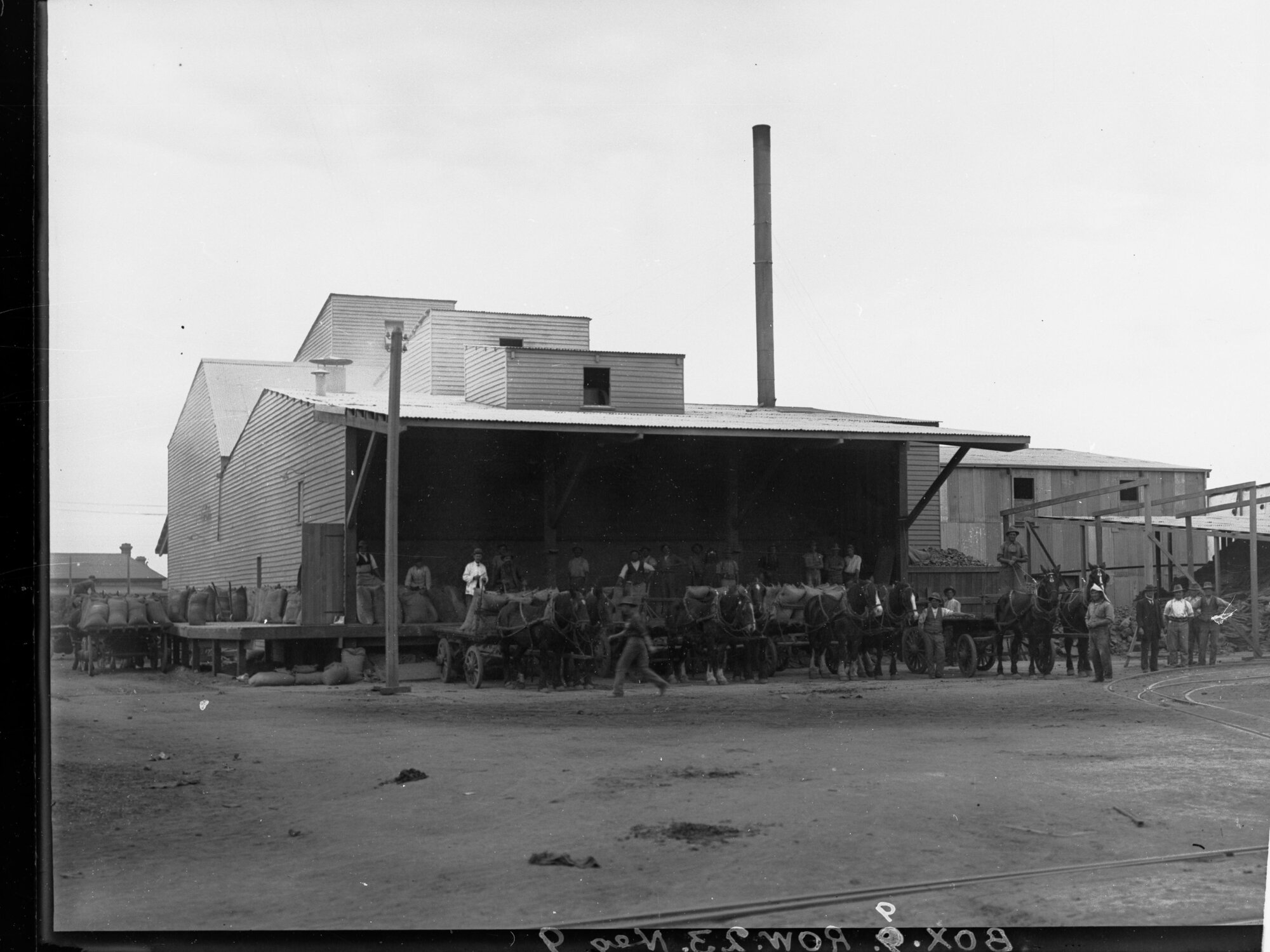 Men loading wheat sacks at flour mill Port Adelaide 