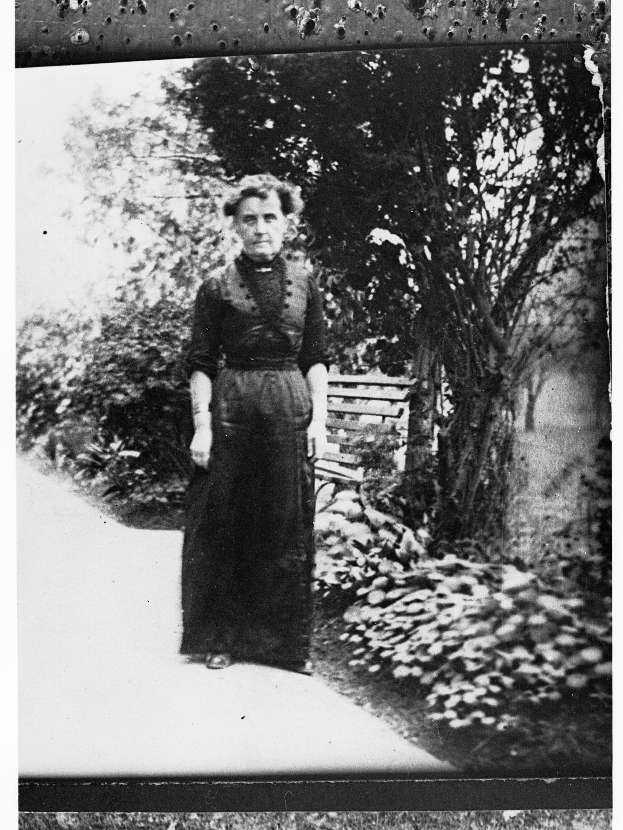 Woman standing in a garden - full length portrait