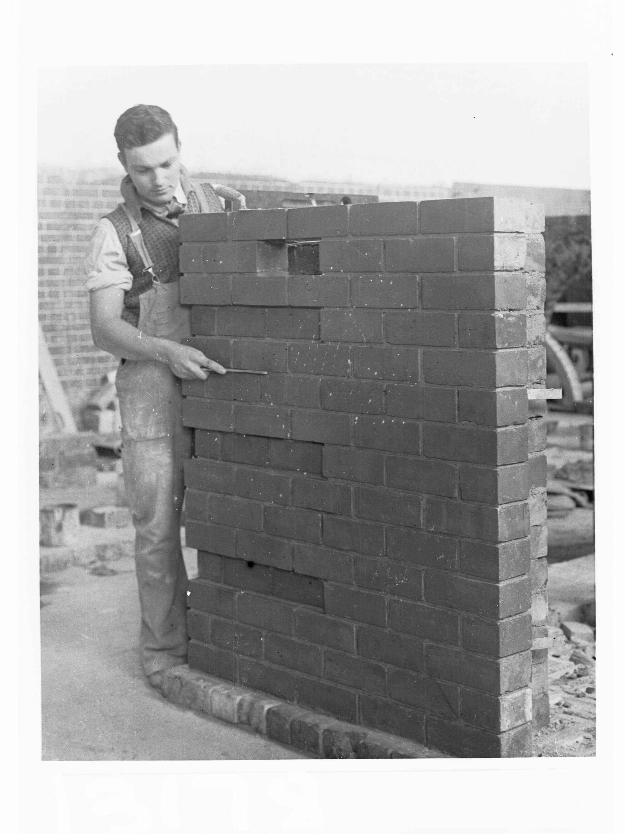 Education Department Trade School showing a student doing brickwork