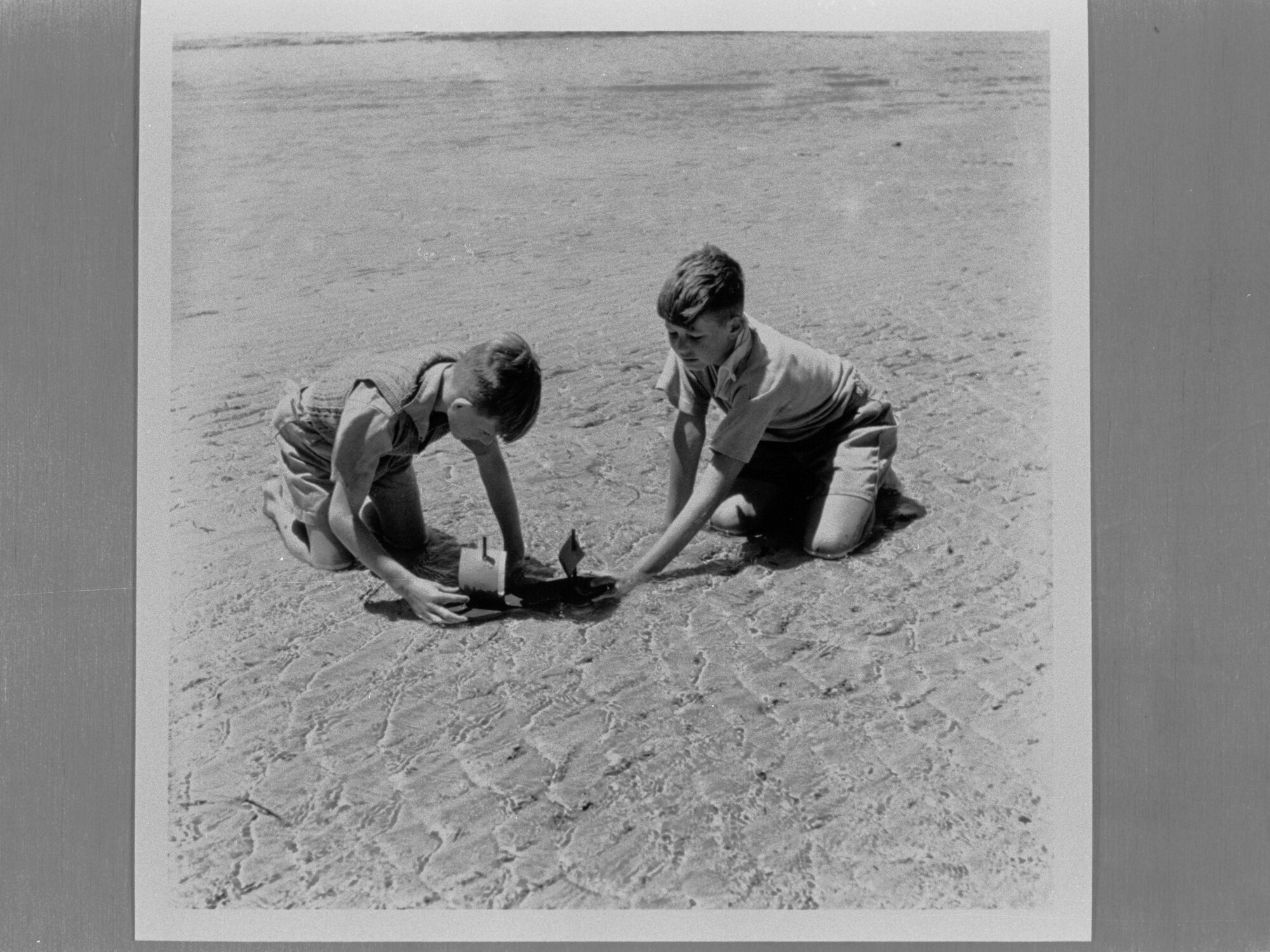 Two boys playing in the sand