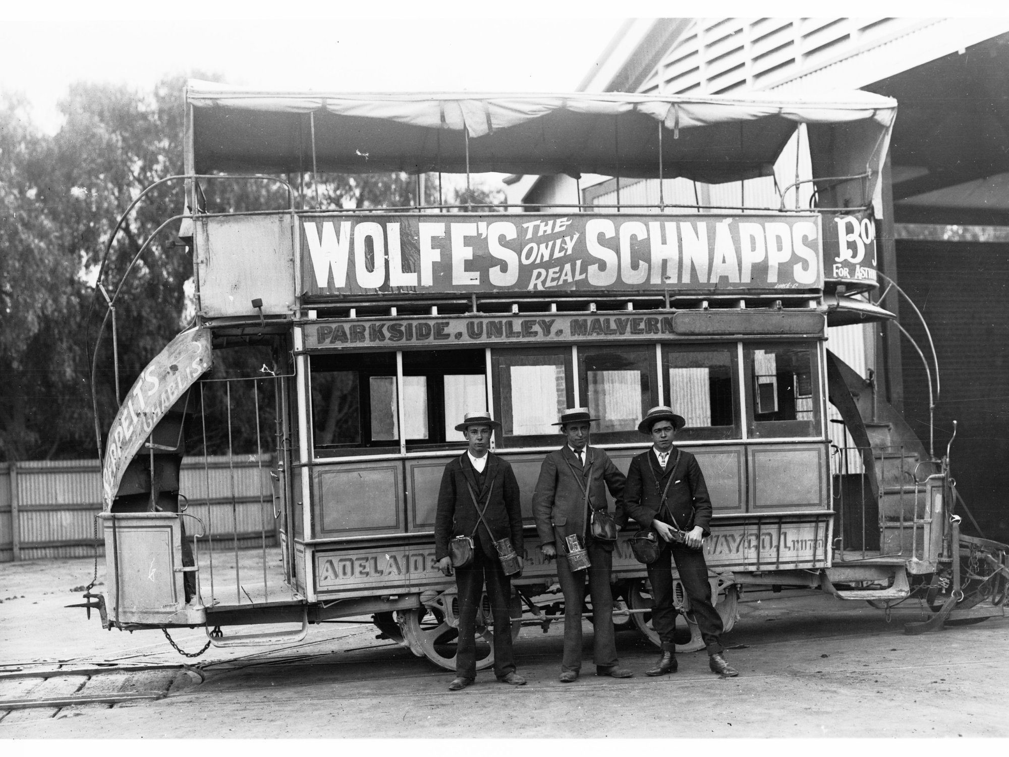 Three Conductors in Front of Horse Drawn Tram