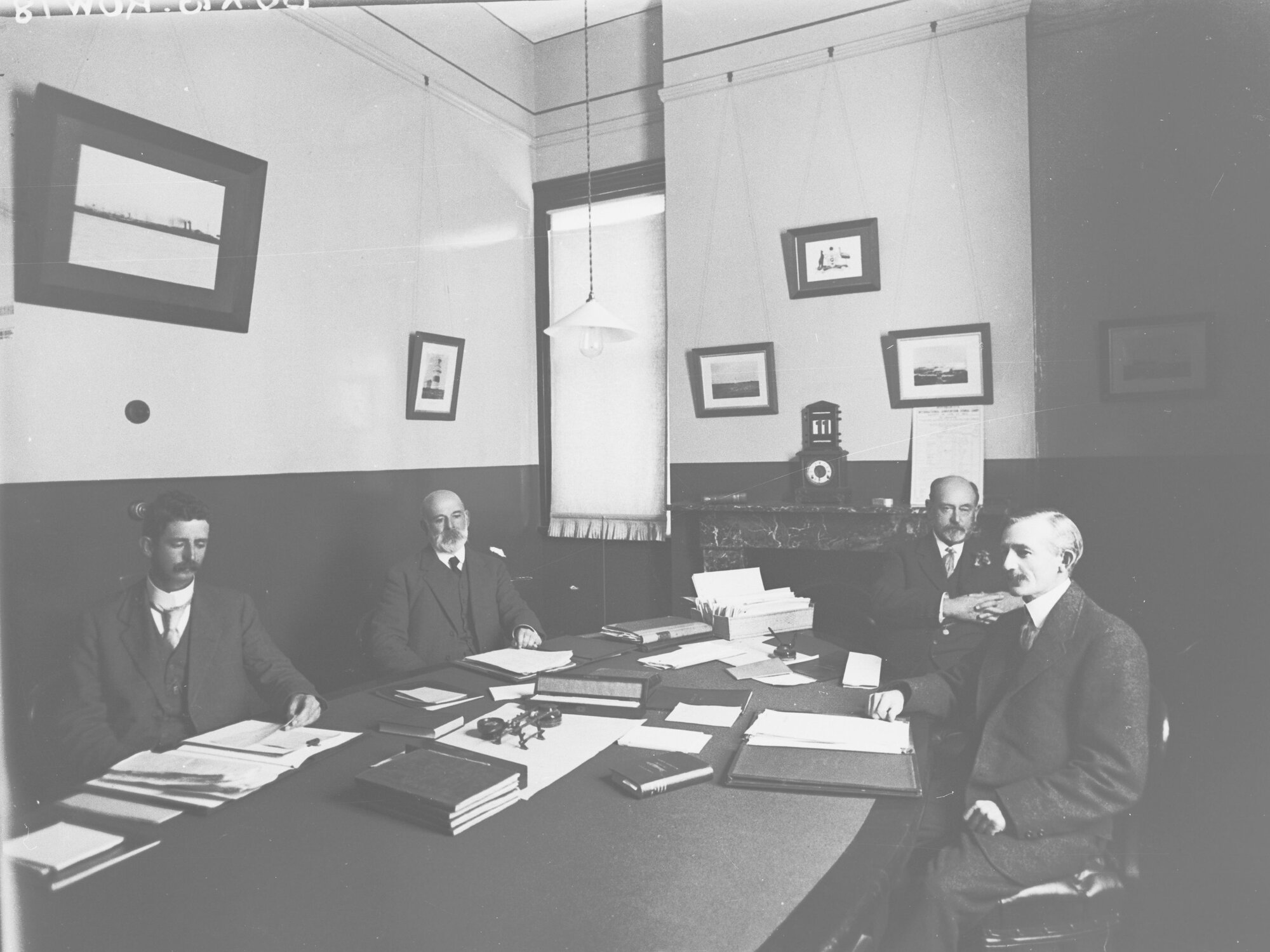 Staff Members of the Harbours Board - sitting at a table in an office