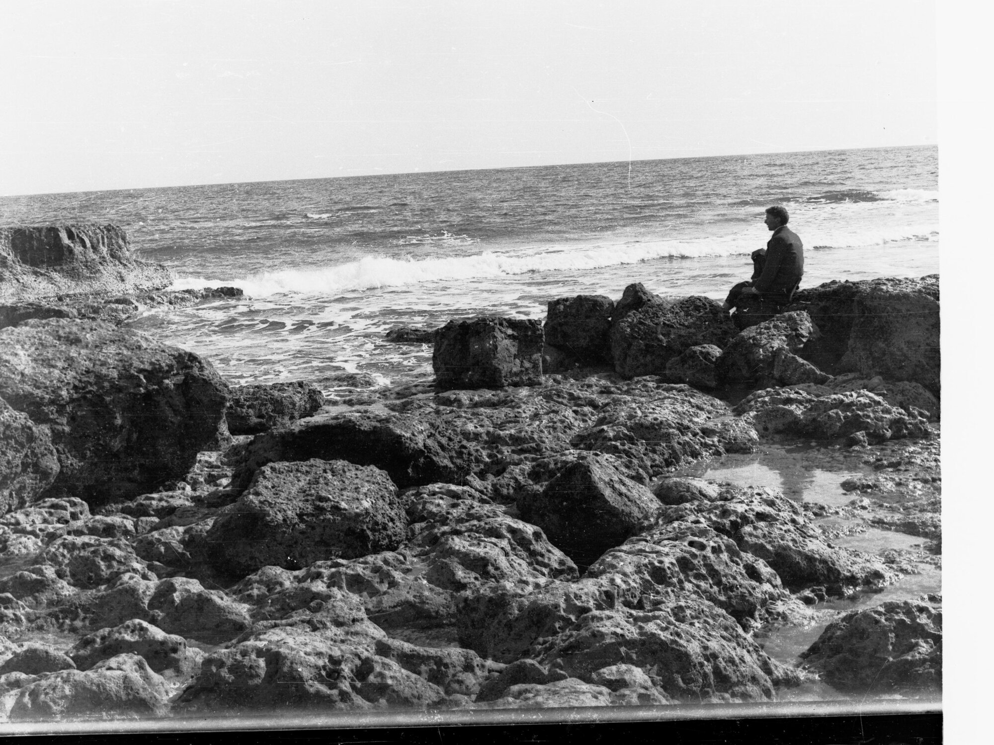 Man sitting on rocks at Port Noarlunga