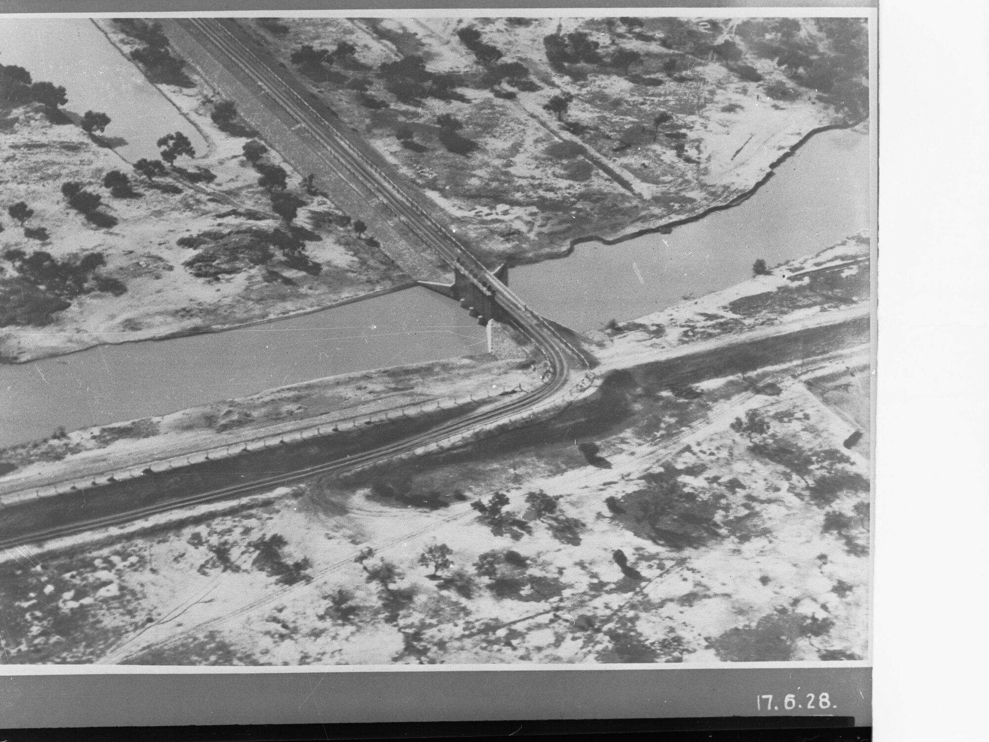 Aerial view of lock and bridge along River Murray showing irrigation channel
