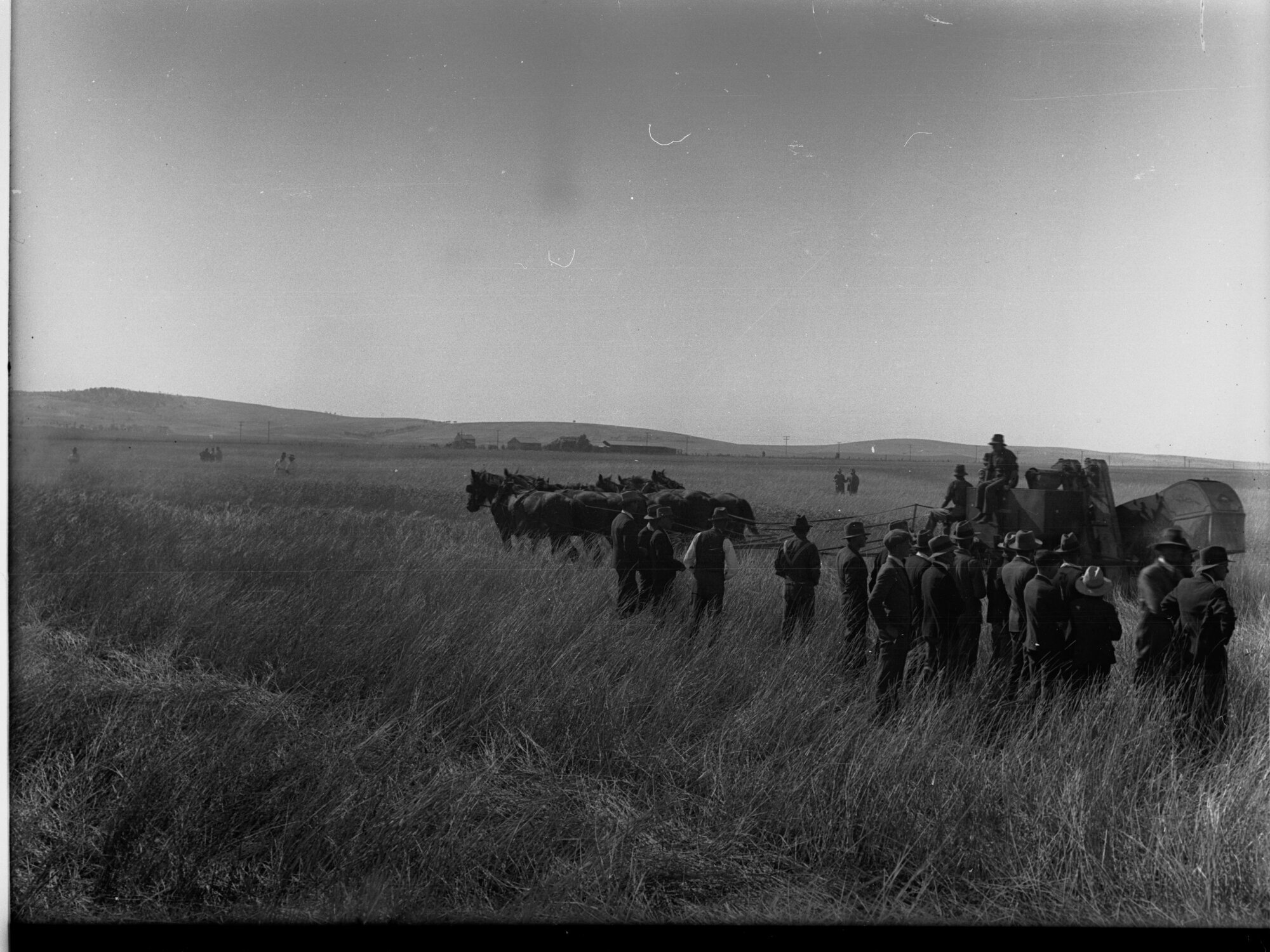 Lake View Field Trials - Men in field by a harvester