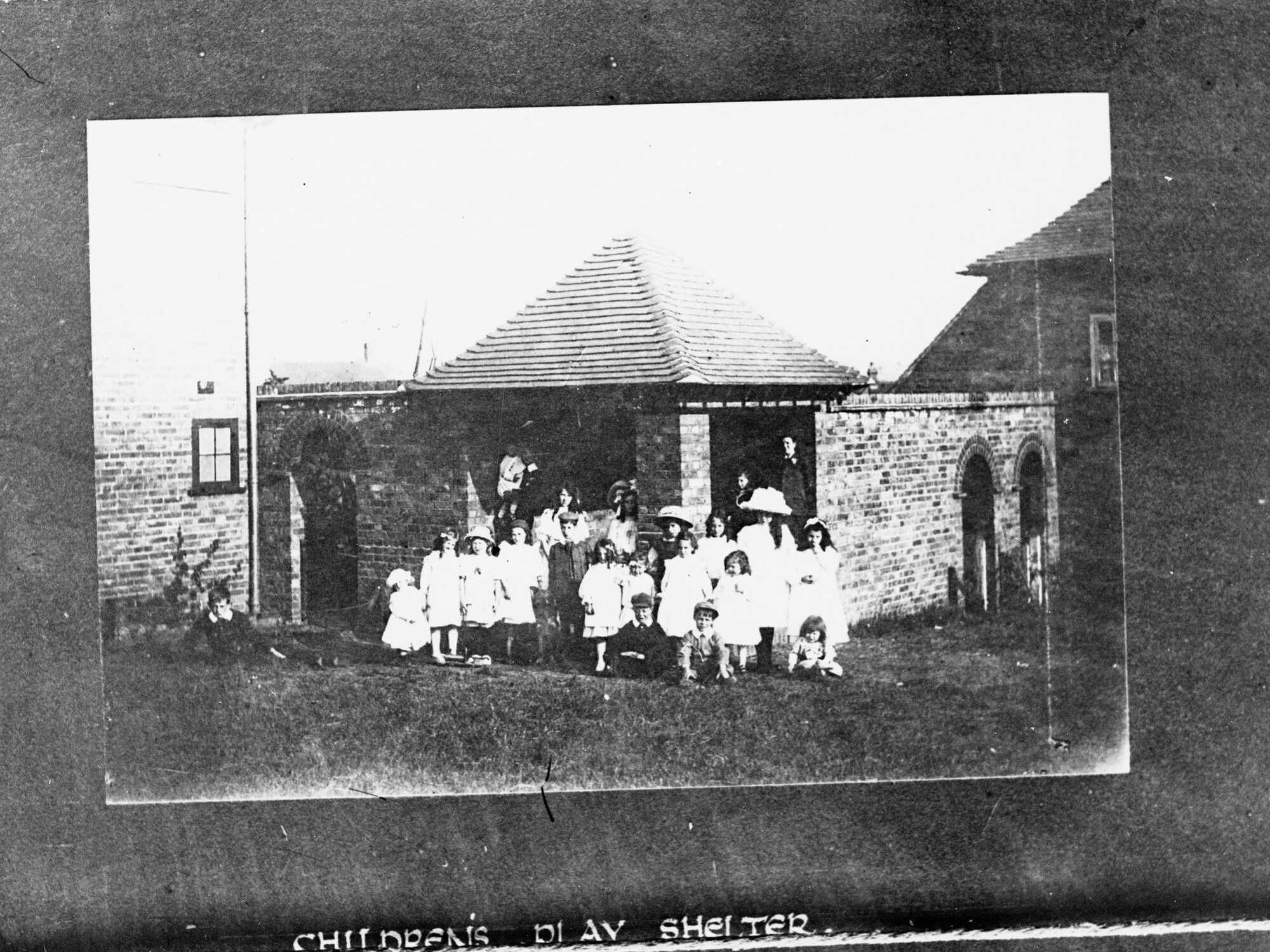 Exterior view of children's play shelter,  shows group of children