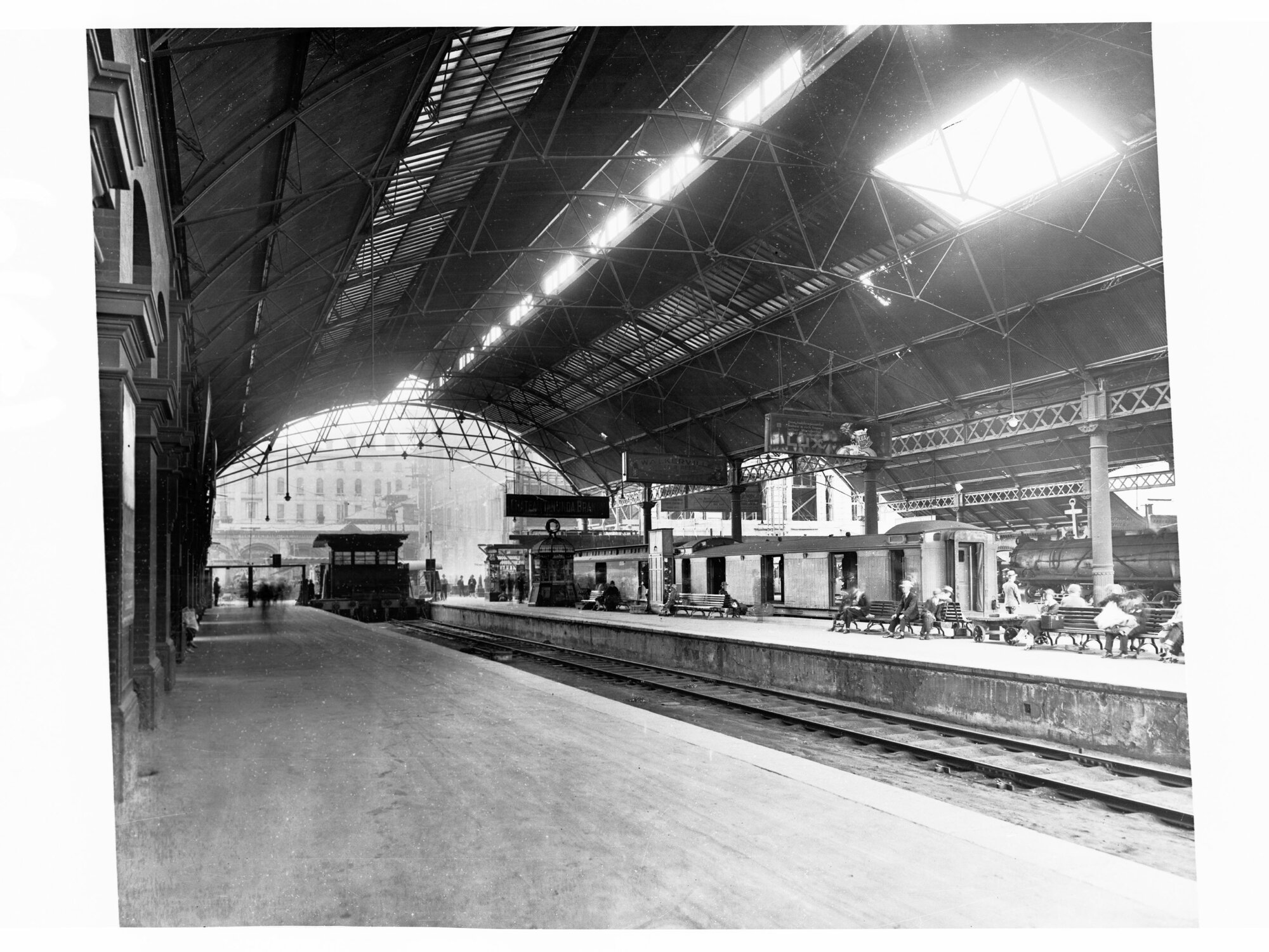 Adelaide Railway Station Showing Platforms and Passenger Sitting on Seats Nearby