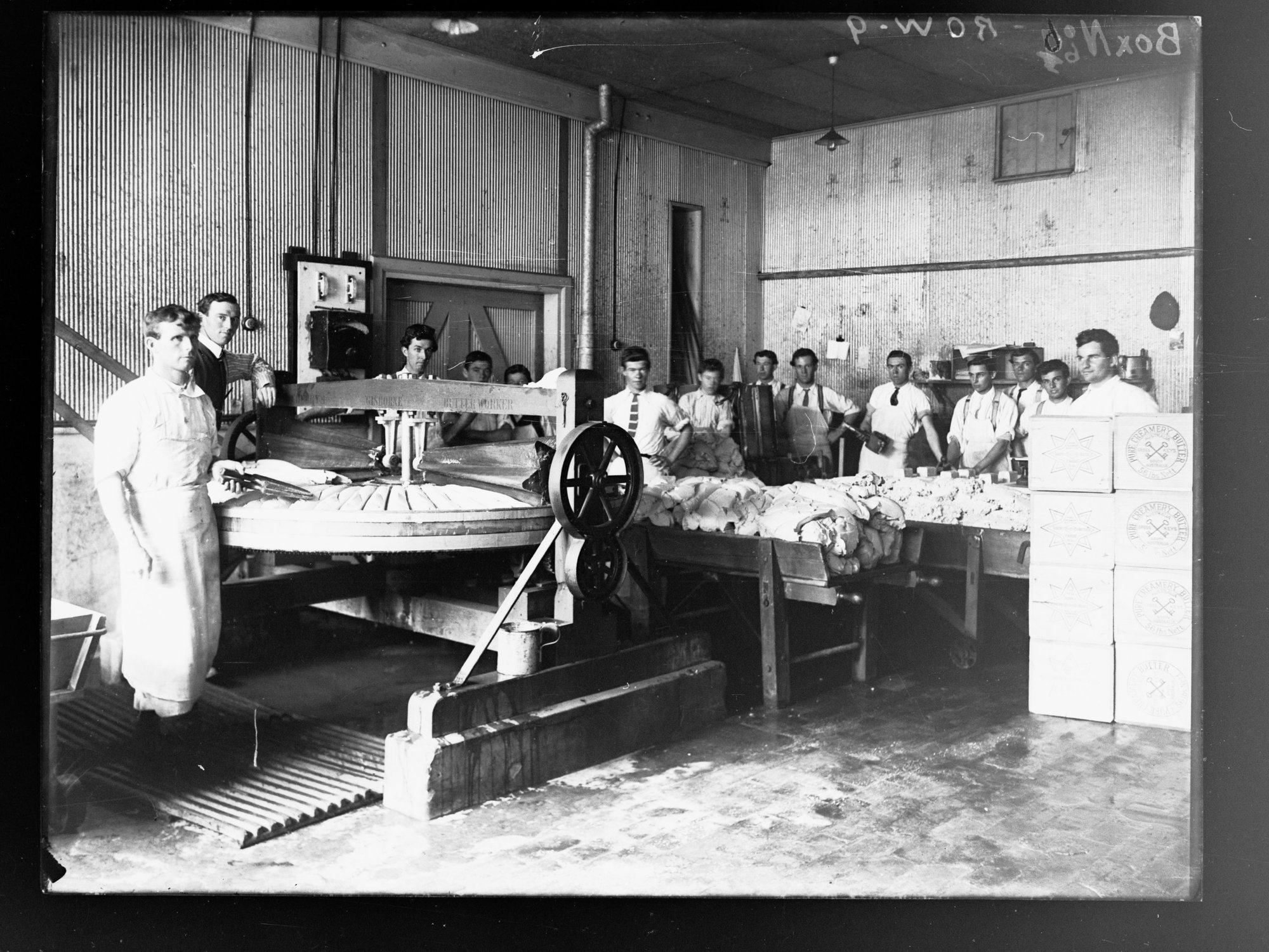 Men working in factory making butter