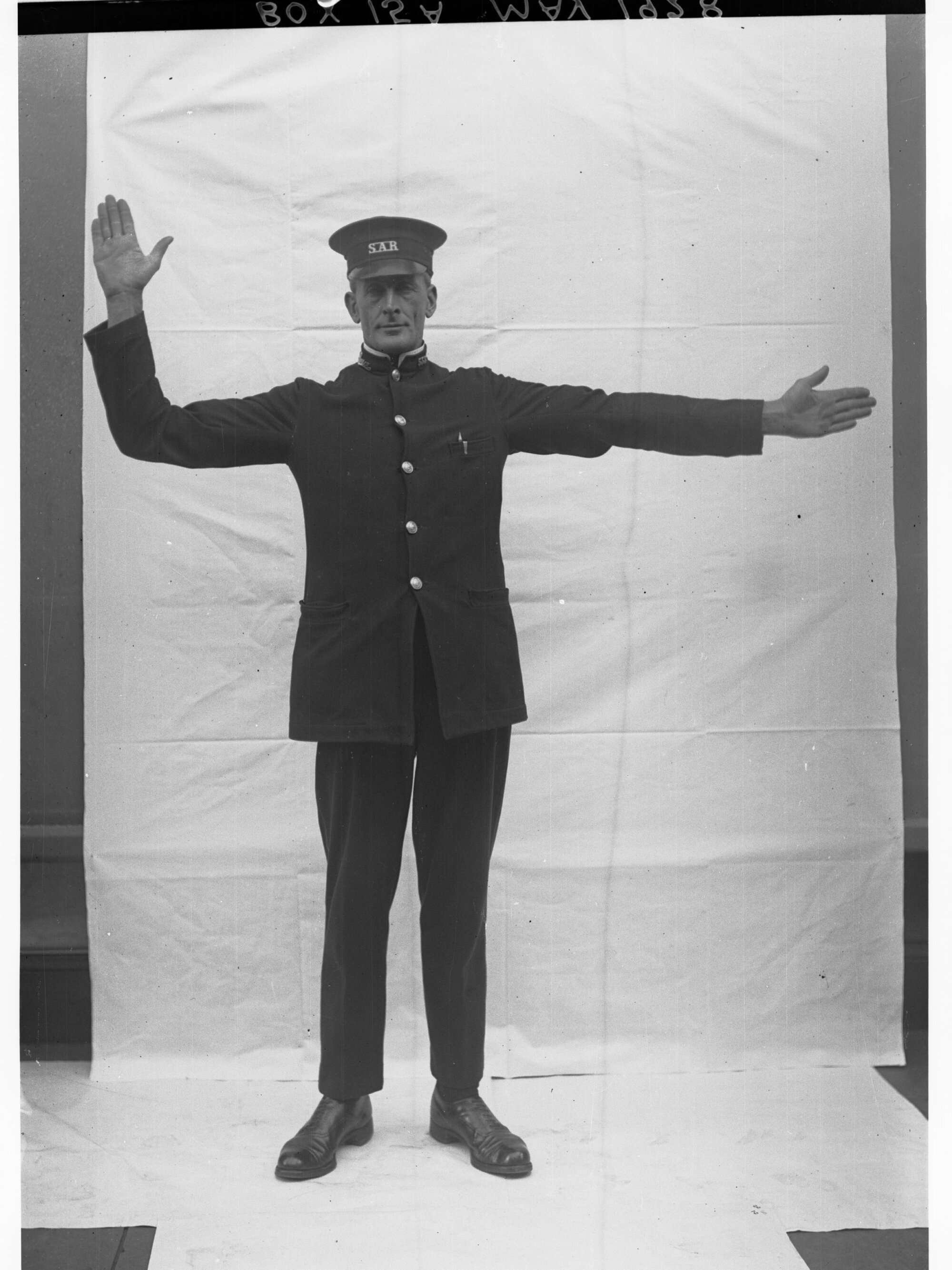 Porter demonstrating railway hand signals