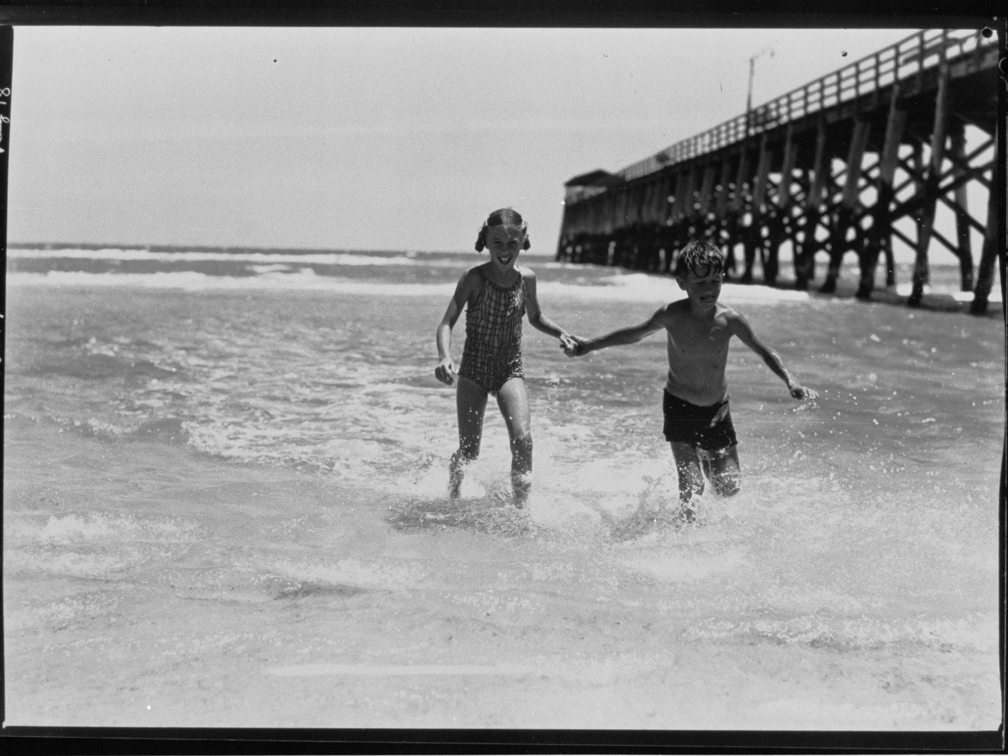 Two children in water near Largs pier