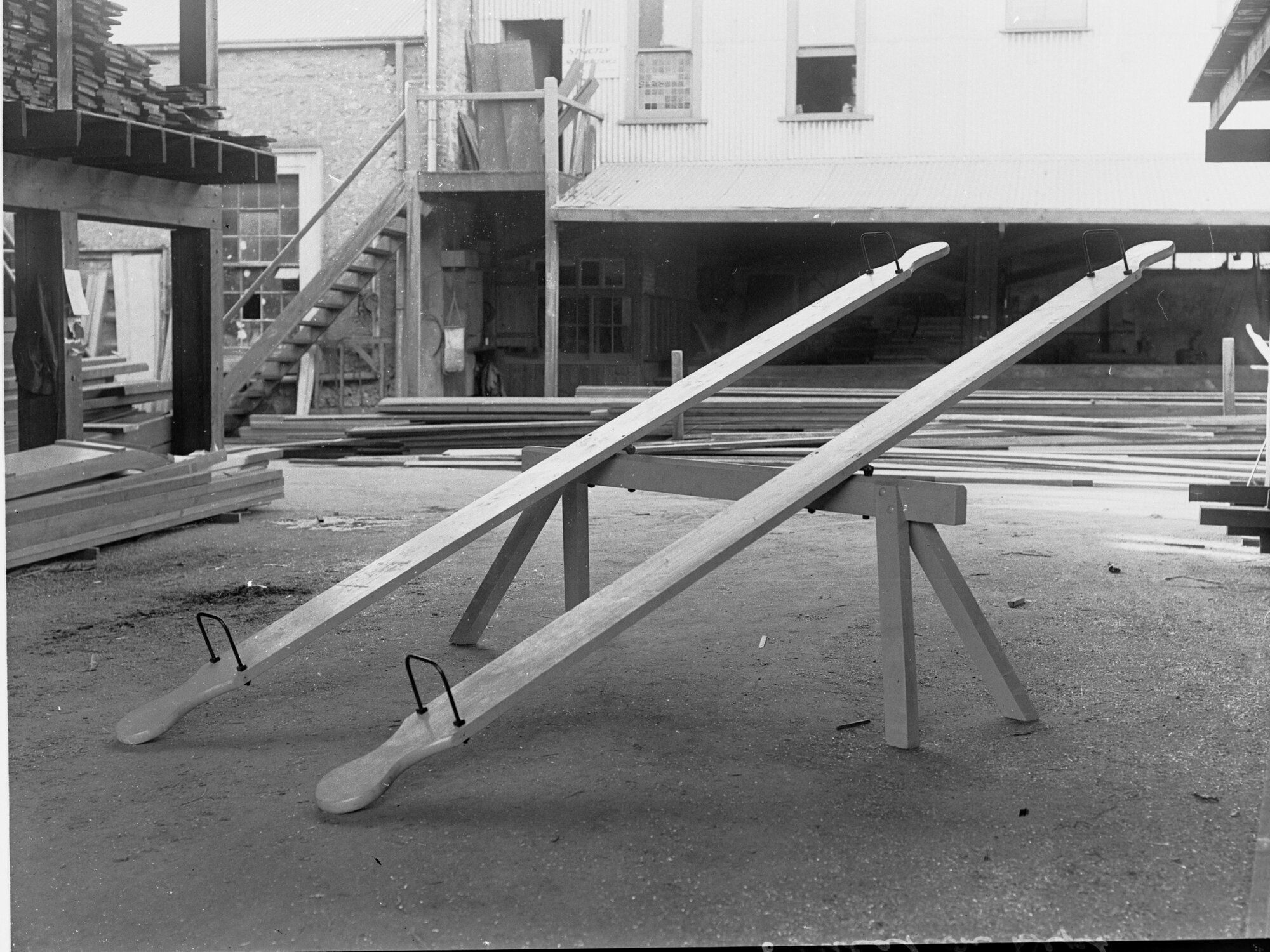 Education Department, South Australia - showing see-saws and back view of the building