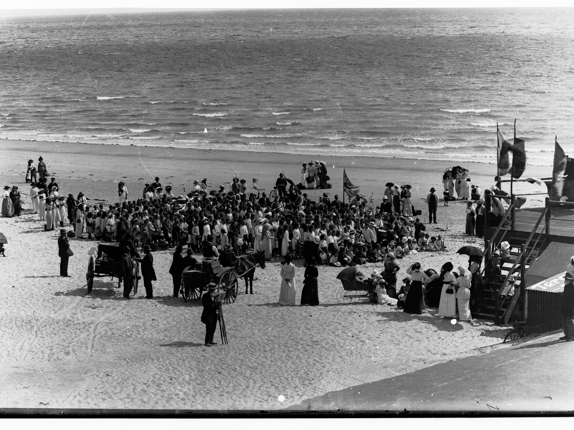 Brighton beach showing crowds of people, and horse and cart