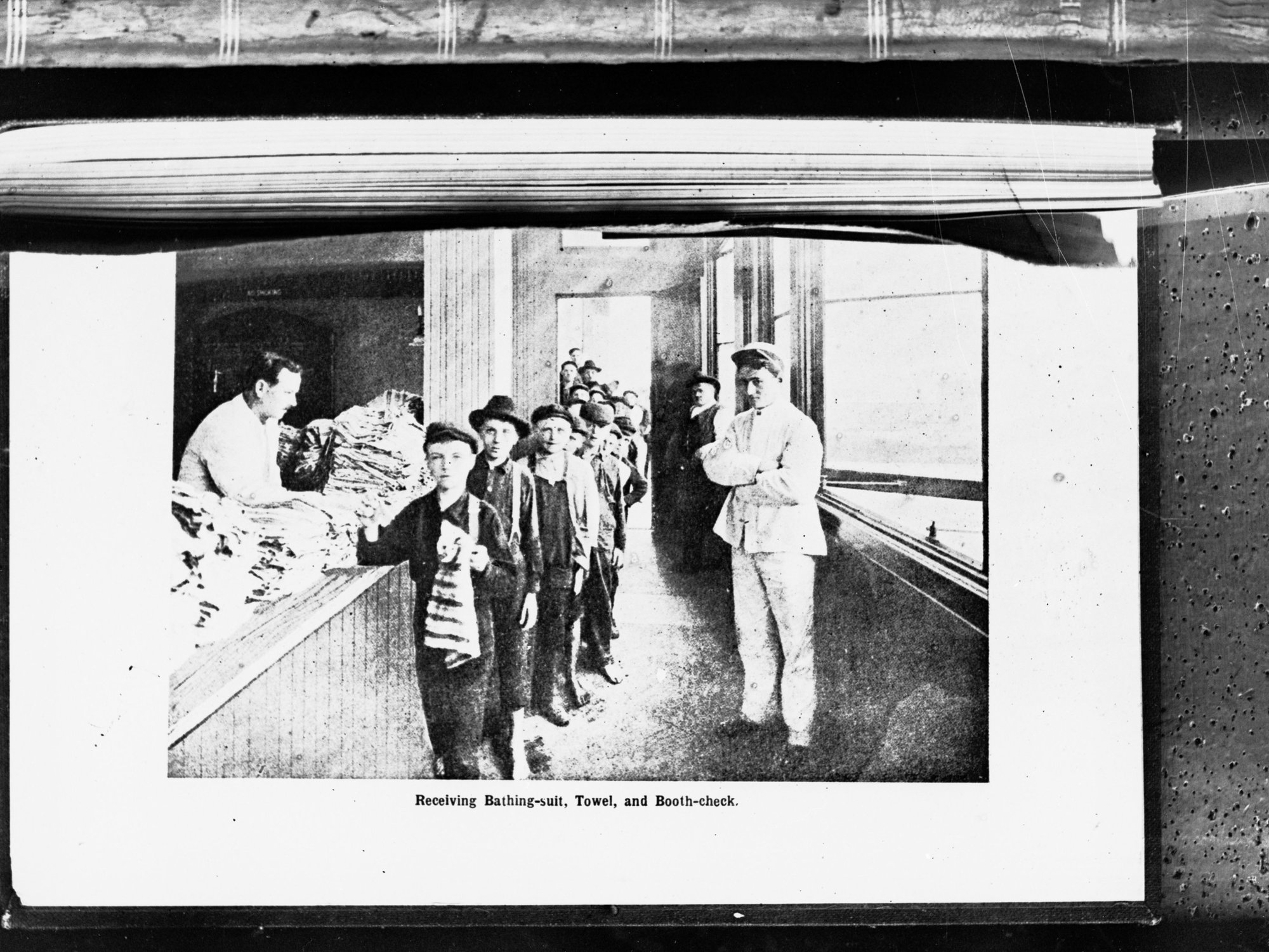 Children receiving bathing suit and towel at booth check,  at children's play shelter