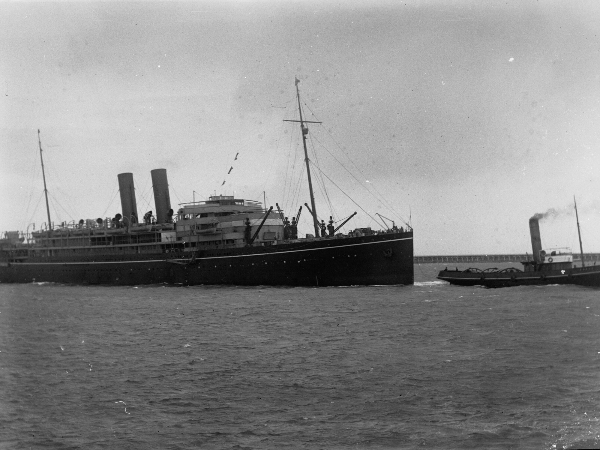 Steamship "RMS Maloja" being tugged by tug boat - Outer Harbour