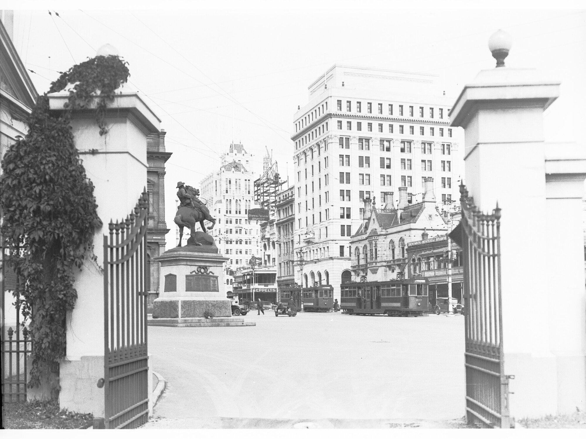 View towards King William Street from Government House gates - shows South Africal (Boer) War Memorial and trams on King William Street