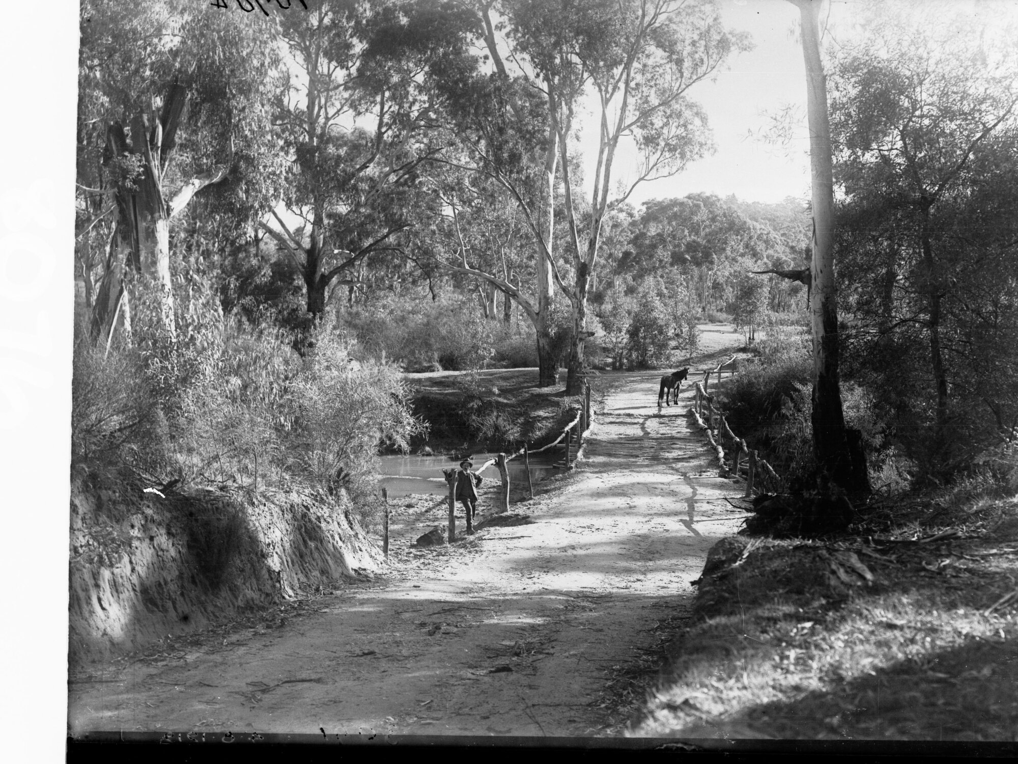 Rural Scene Showing Pathway and Bridge with Man at Side and Horse